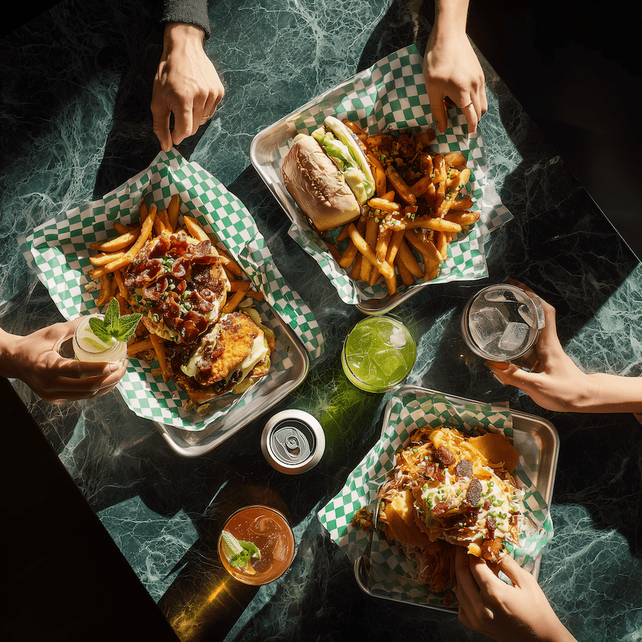 Chicken sandwhiches and drinks on a green marble table