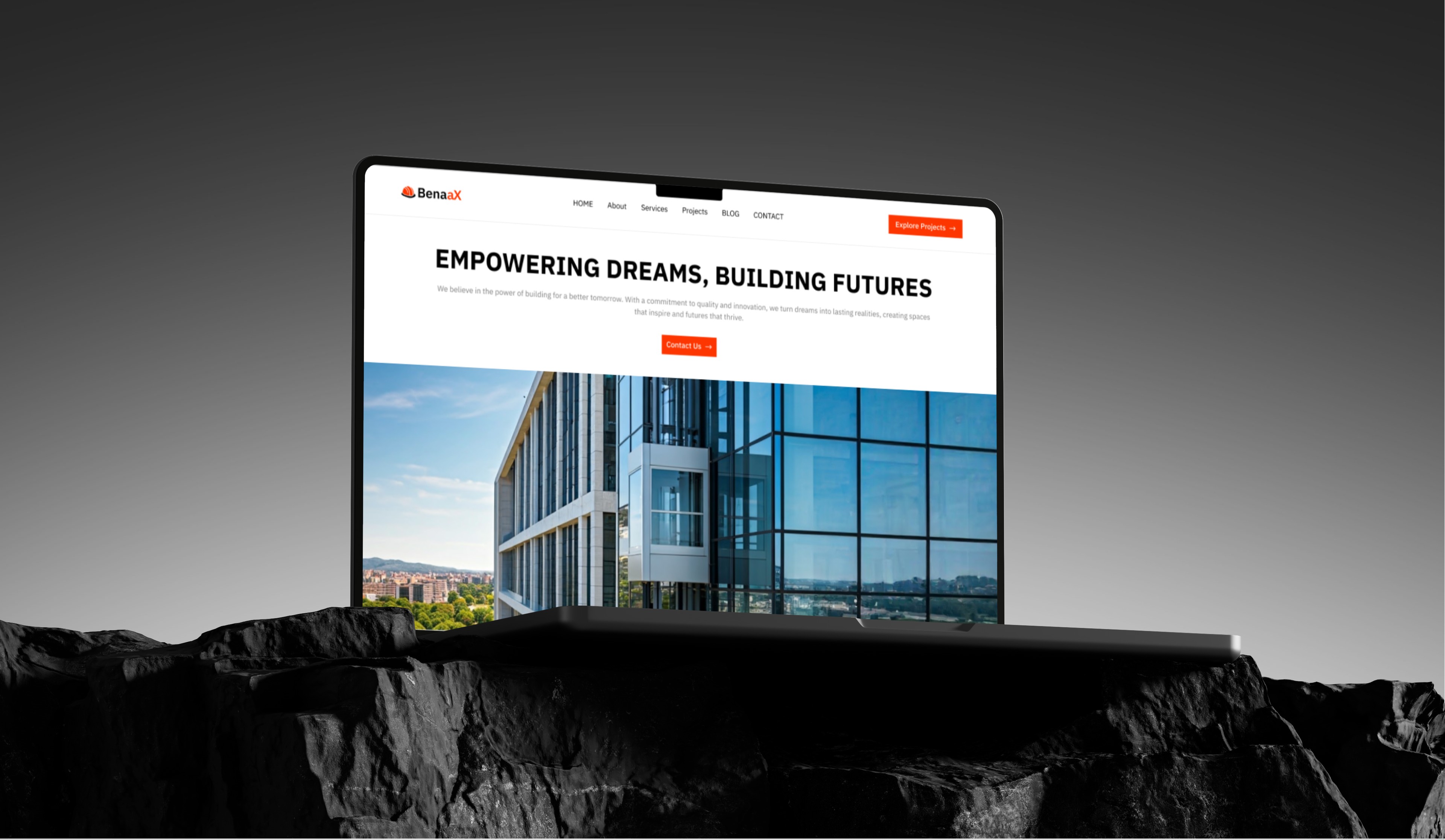Laptop displaying a website homepage with the tagline "Empowering Dreams, Building Futures".  The website showcases images of modern architecture.
