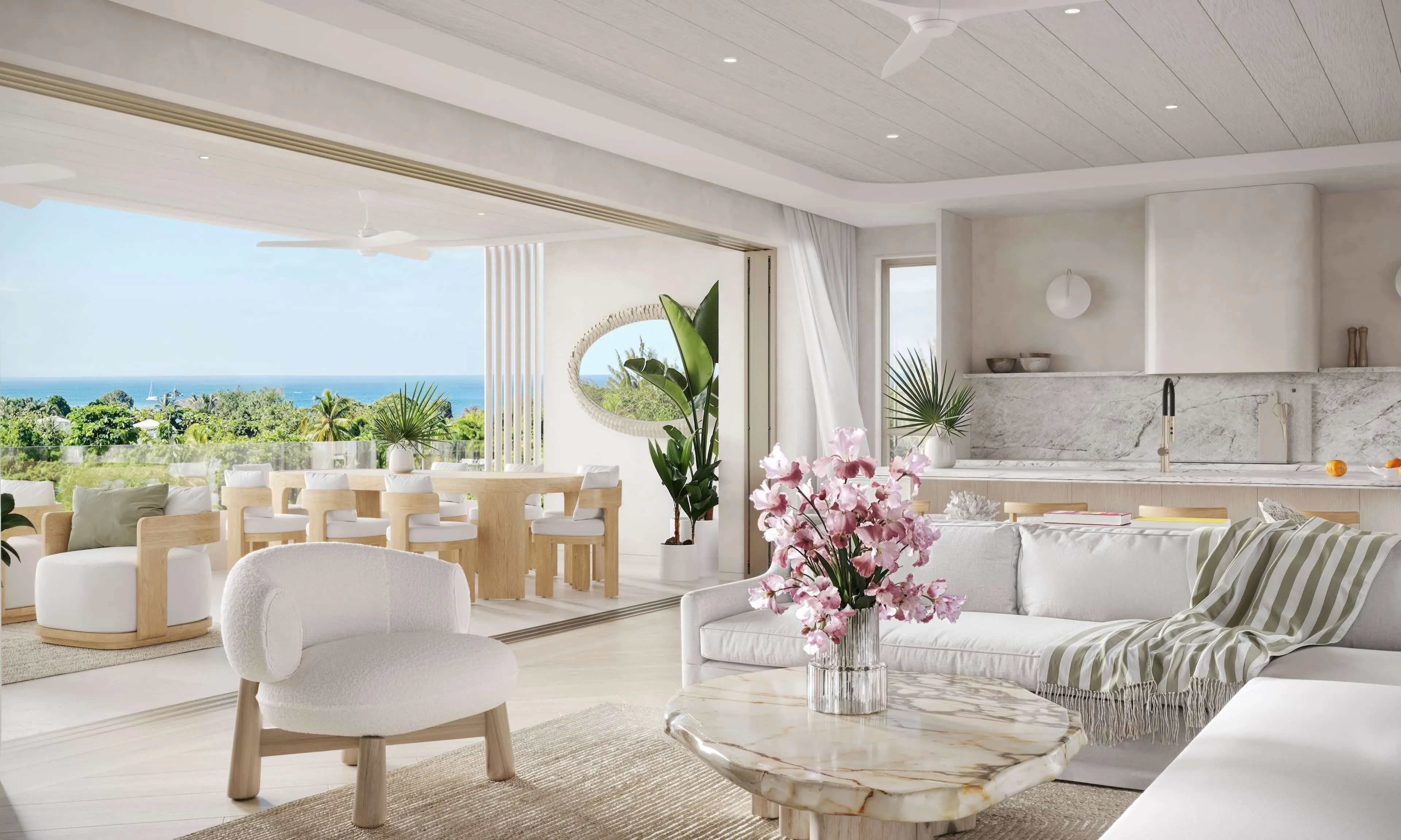 Bright, modern living room with white furnishings, open space, and a view of lush greenery outside.