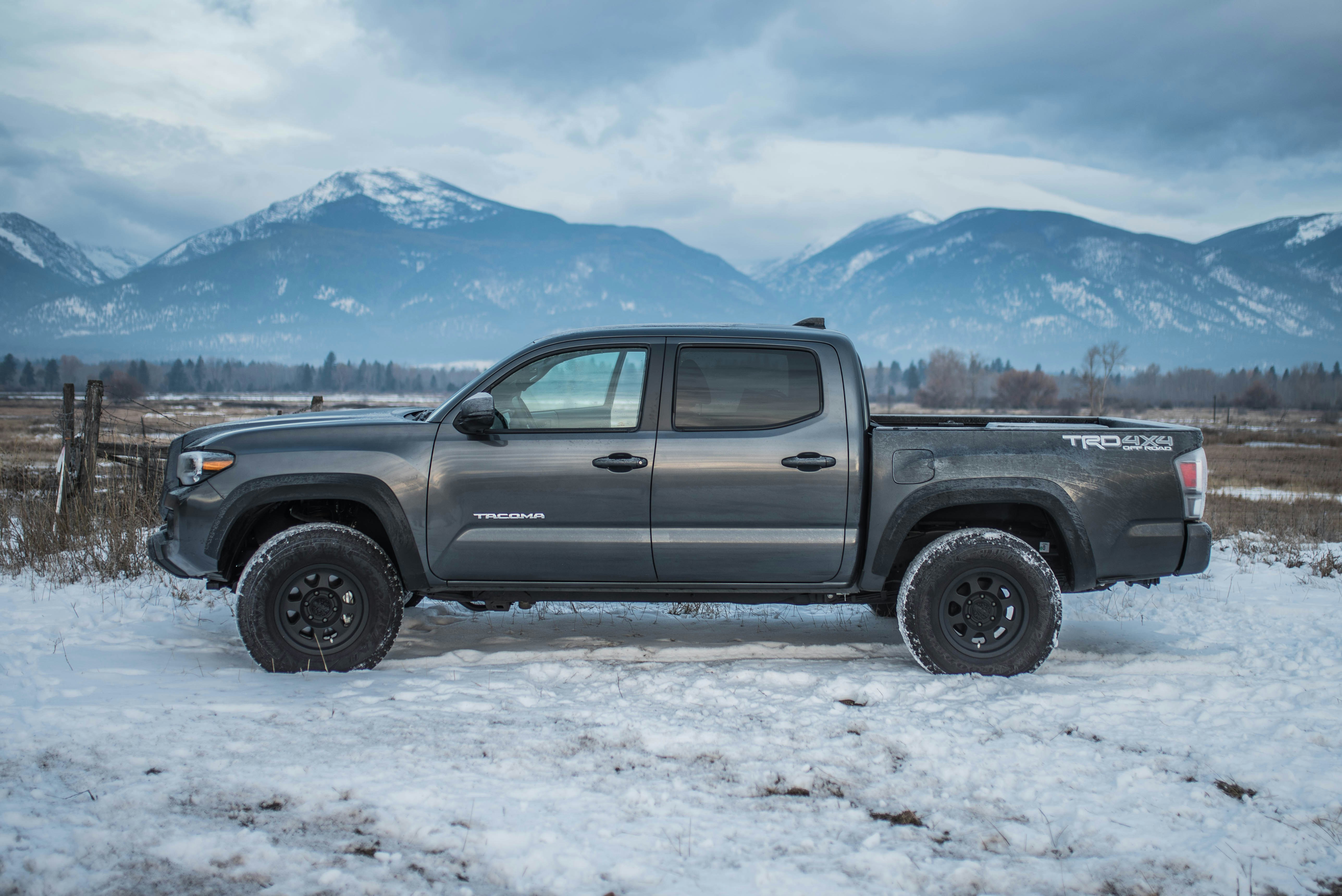 The gray 2020 Toyota Tacoma TRD Sport in the snow, from the side