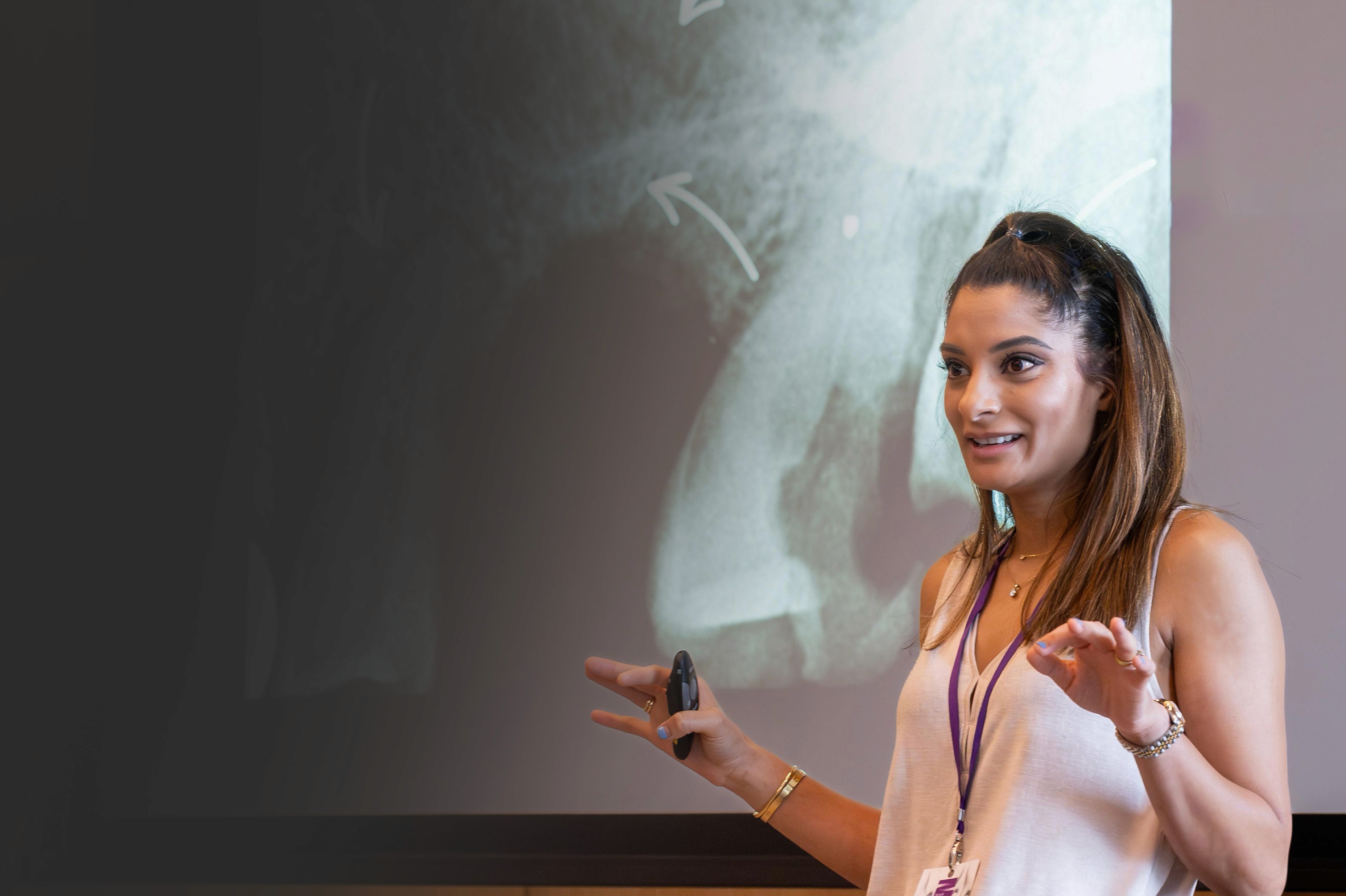 Portrait of Dr Kreena Patel presenting to an audience