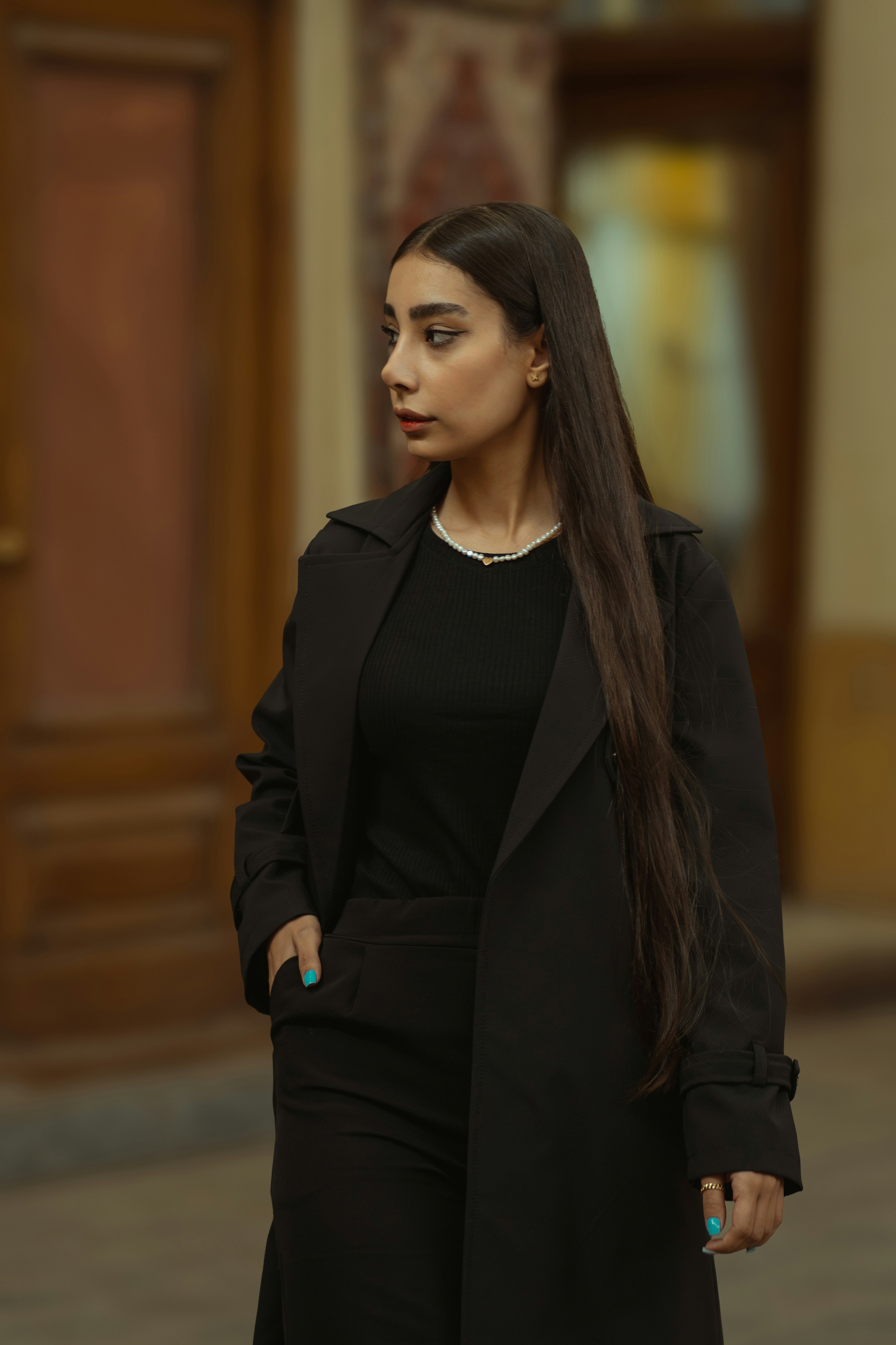 A woman with long hair walking down a street