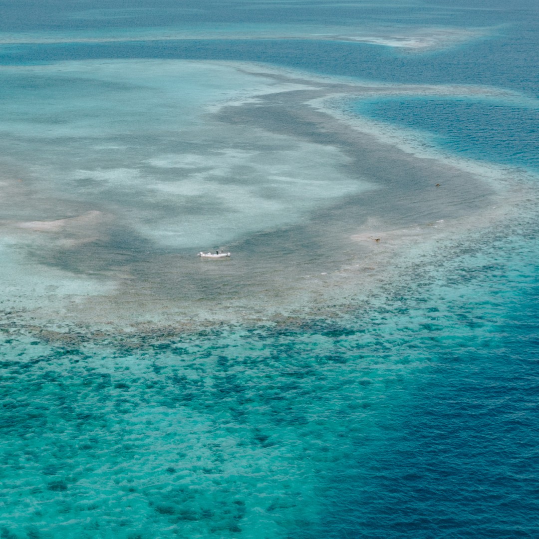 Aerial image of a turqouise pancake flat outside Placencia in Belize