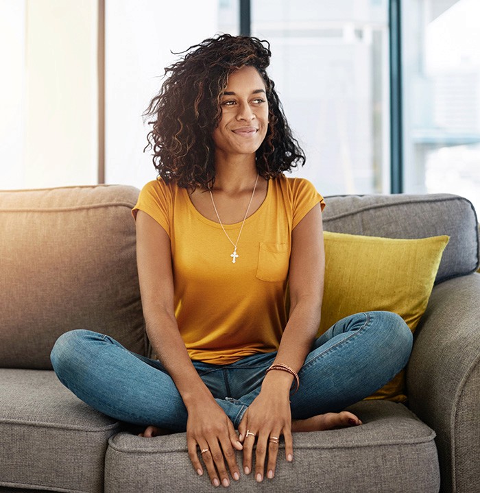 content woman sitting on couch