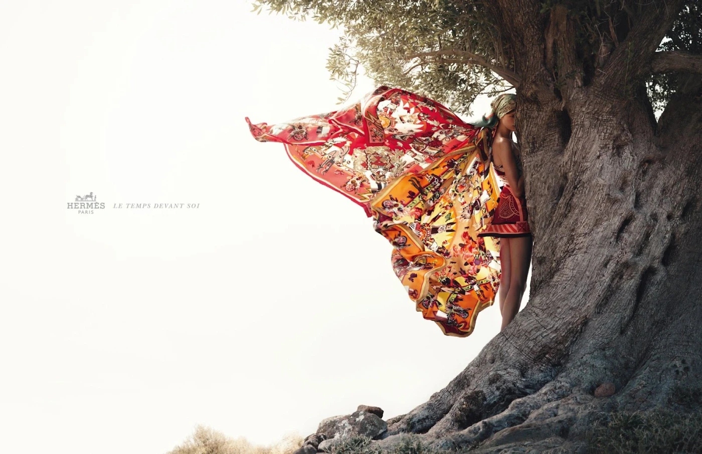 Woman by a tree with butterly wings made of fabric