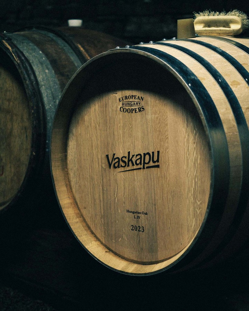 Oak wine barrel engraved with the Vaskapu logo inside the Mohács cellar, designed and photographed by Marcell Kazsik for Vaskapu Winery — capturing the artisanal Hungarian craftsmanship and the tactile identity of the brand. Photo by @simanadam / Lees Brothers