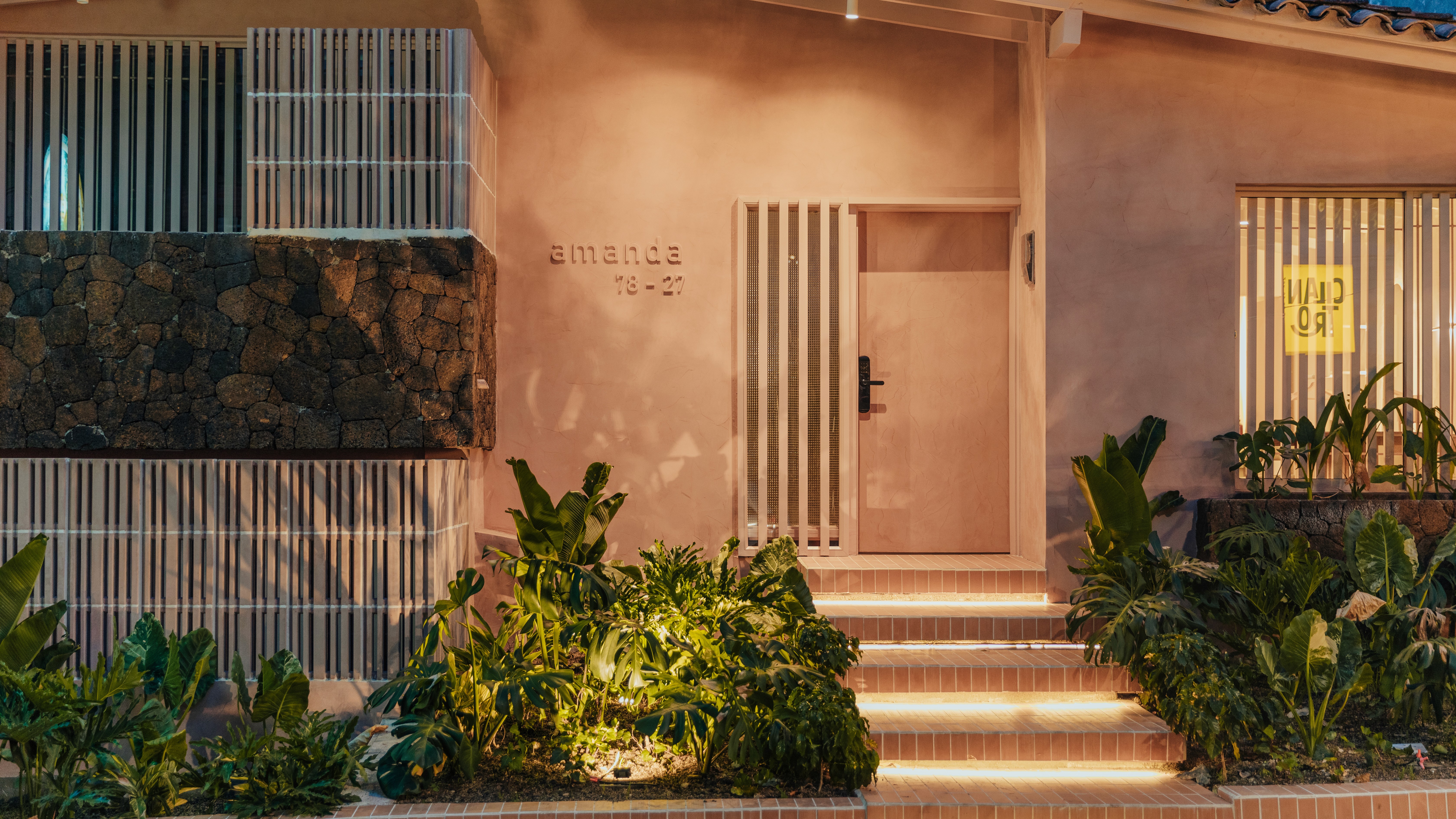 Double-height interior with flowing sculptural forms and warm raking light