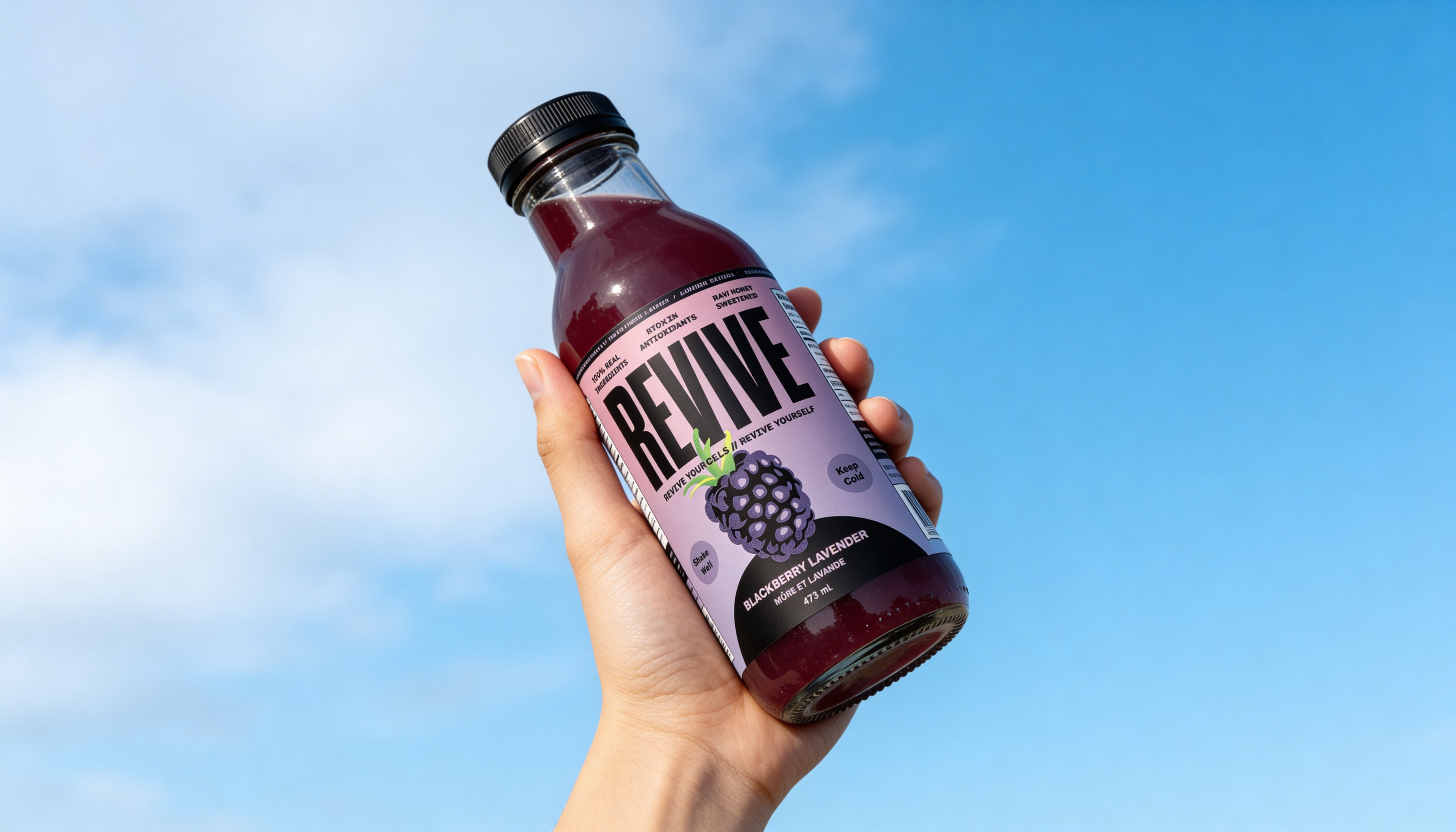 A hand holding a juice beverage brand botle design in the air