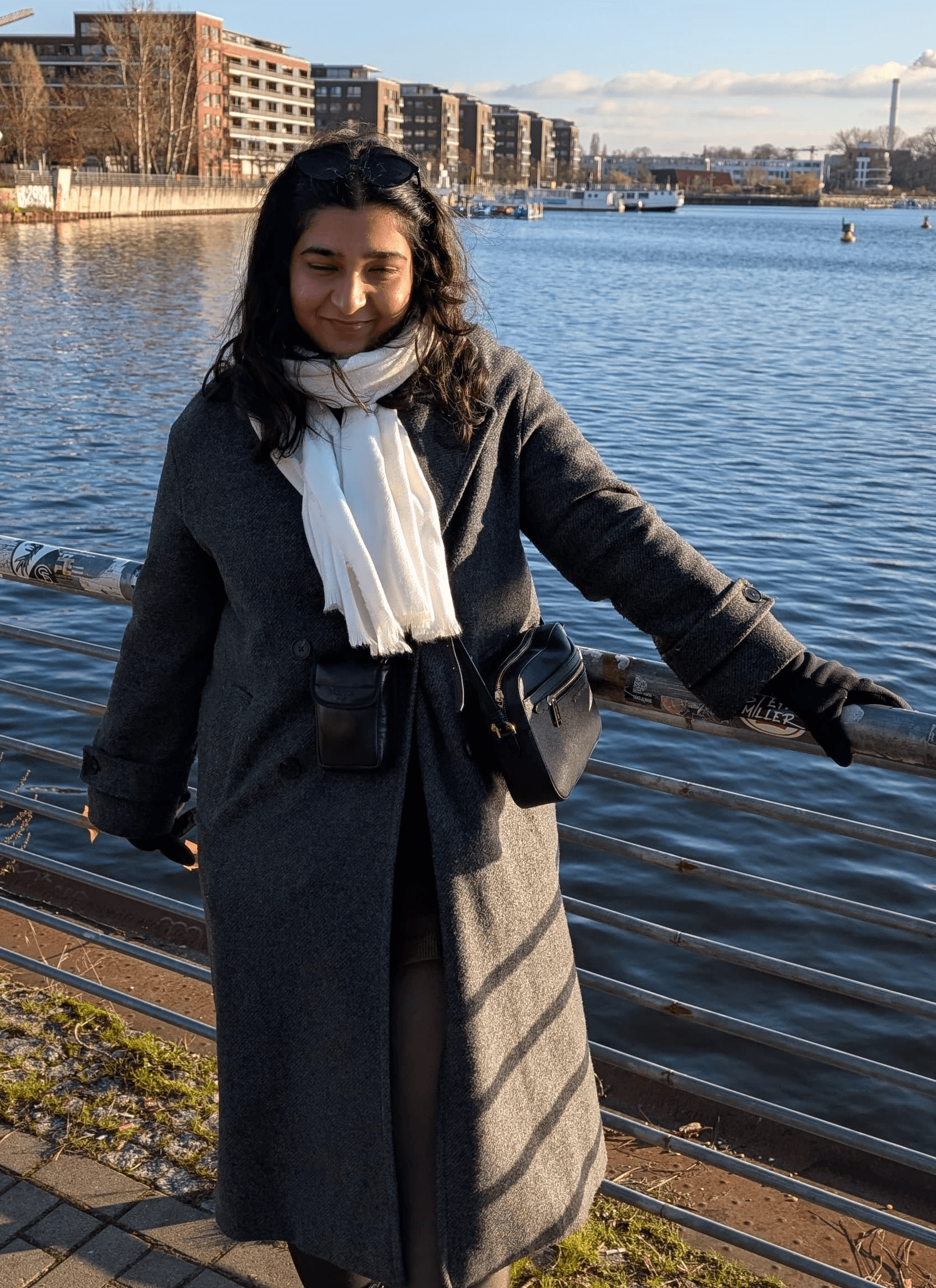 A thoughtful young person with dark hair gazes to the side, captured in soft black and white lighting.