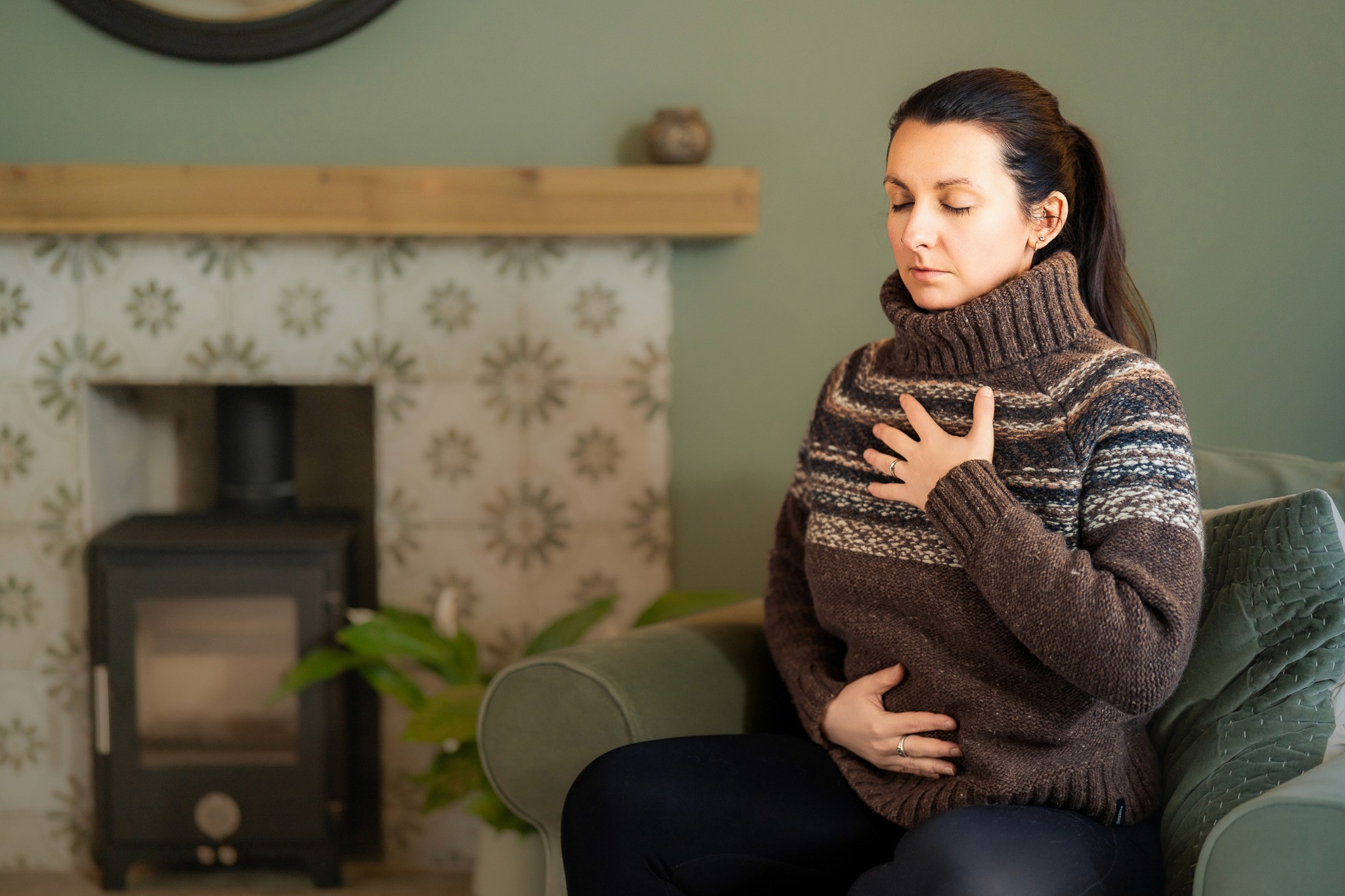 Bronwyn Benstead sat with hands on her belly and chest