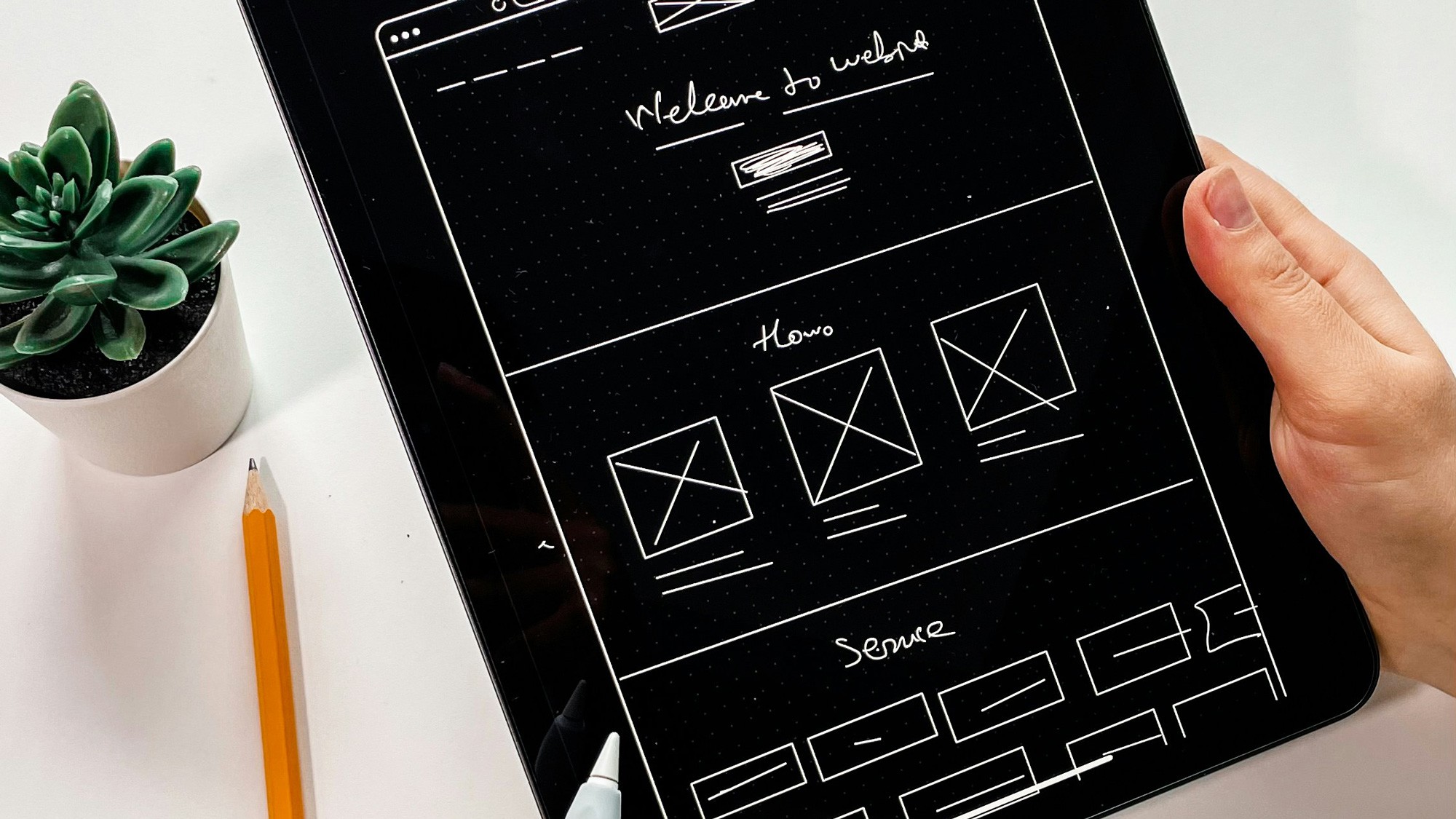 An ipad with a product wireframe on the screen