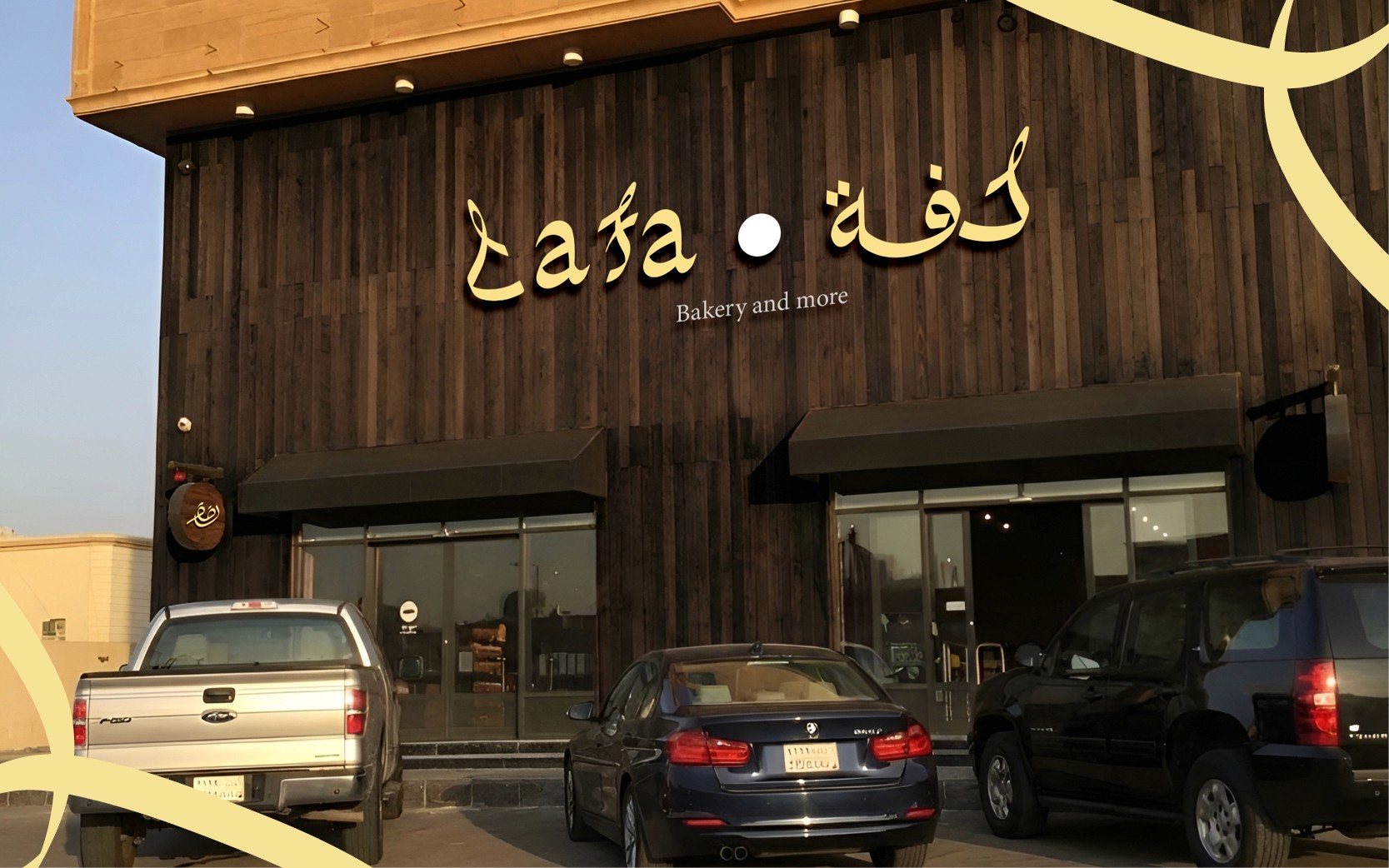 Modern home office setup with a monitor, ergonomic chair, keyboard, and indoor plants near a window with blinds.