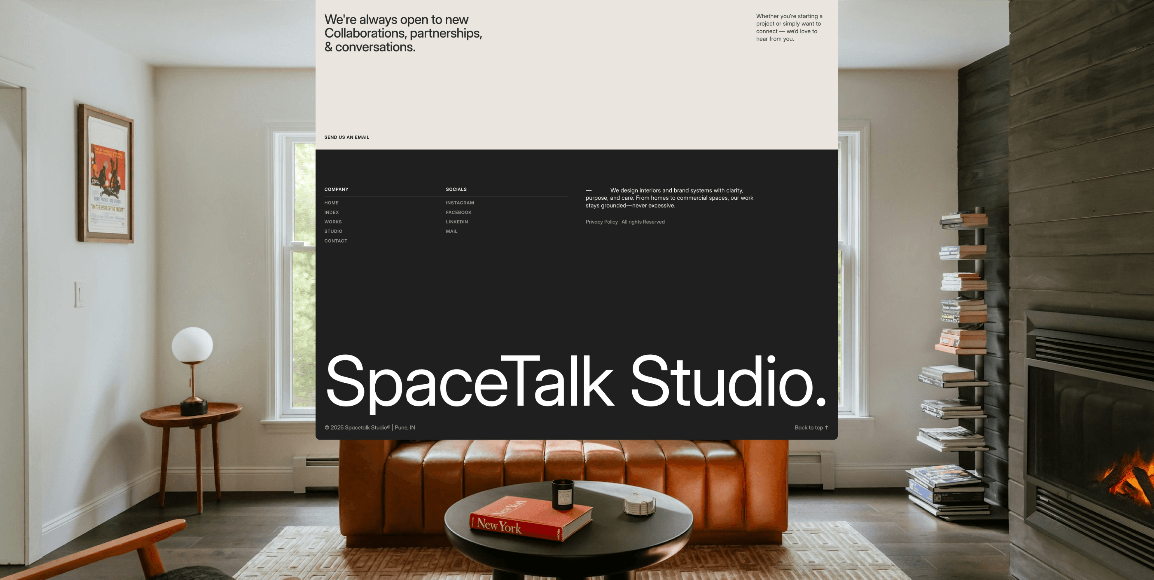 A modern, cozy living room with a rich brown leather sofa, a dark wood coffee table, a tall stack of books, and a sleek fireplace, featuring large windows that let in abundant natural light, with an overlay displaying “SpaceTalk Studio” in large text.