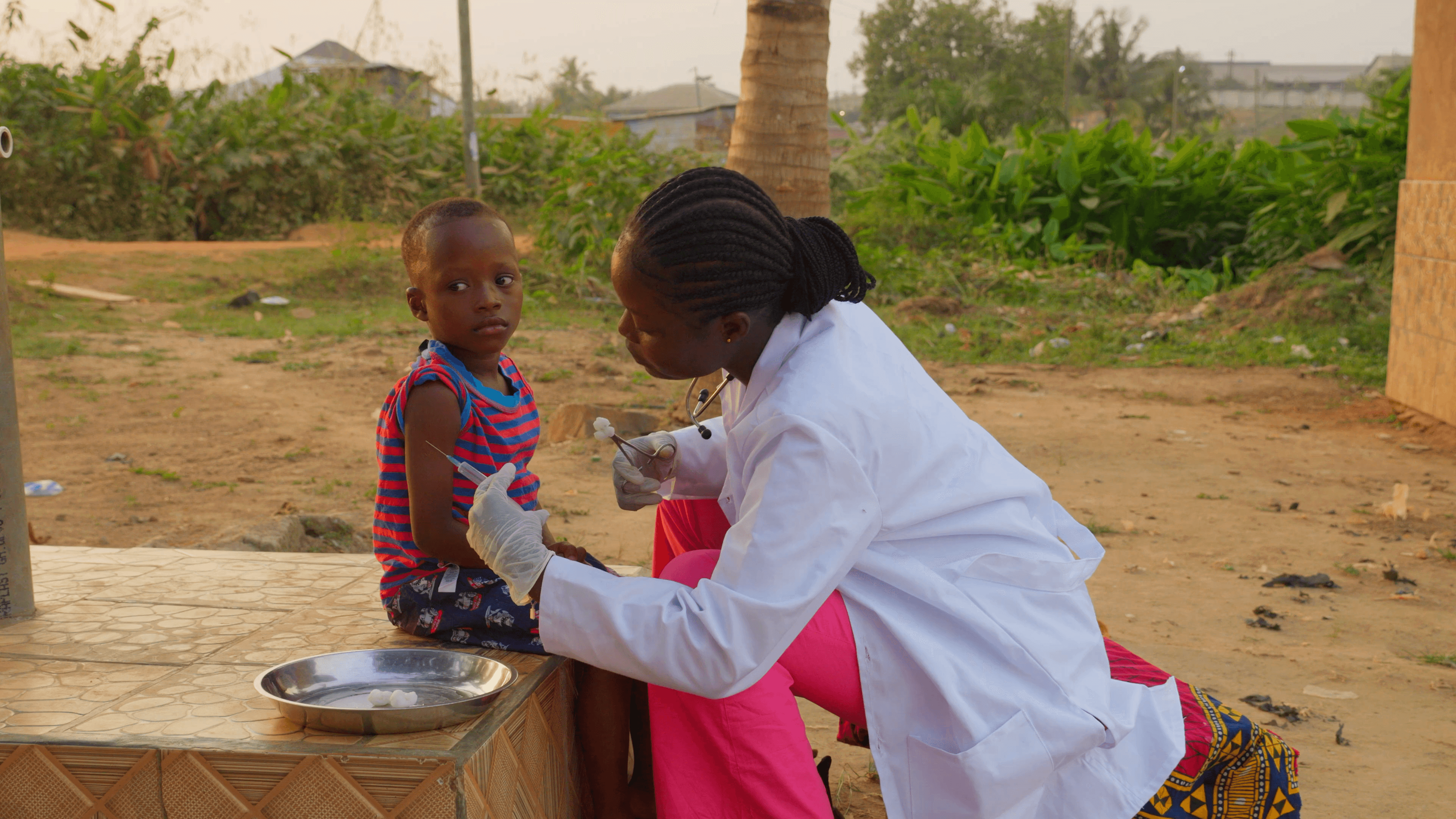 boy in white shirt drinking water from bottle