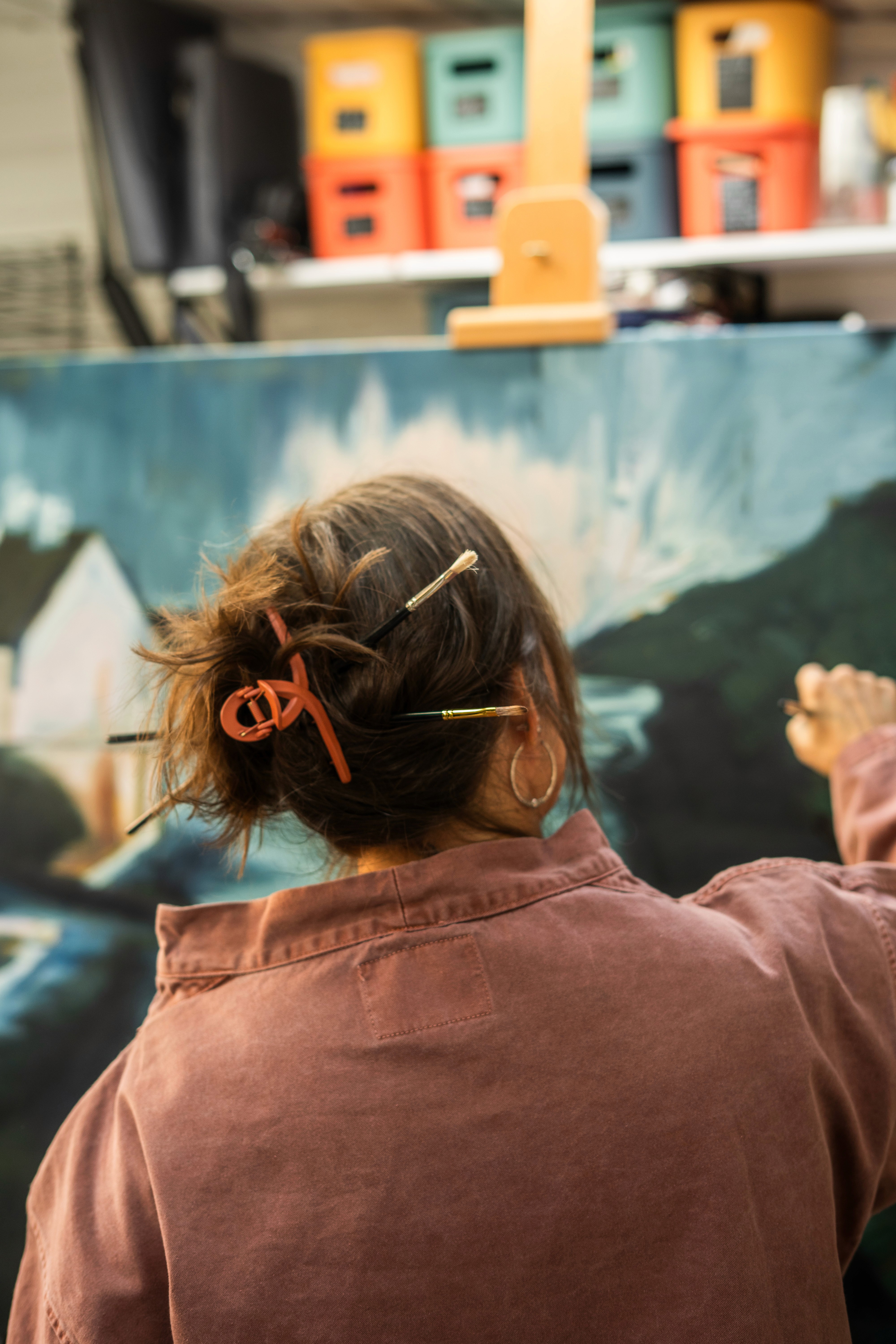 A modern gallery with paintings and skylights