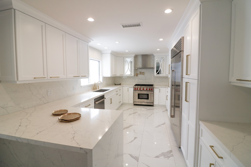 classic white shaker kitchen cabinetry with gold handles