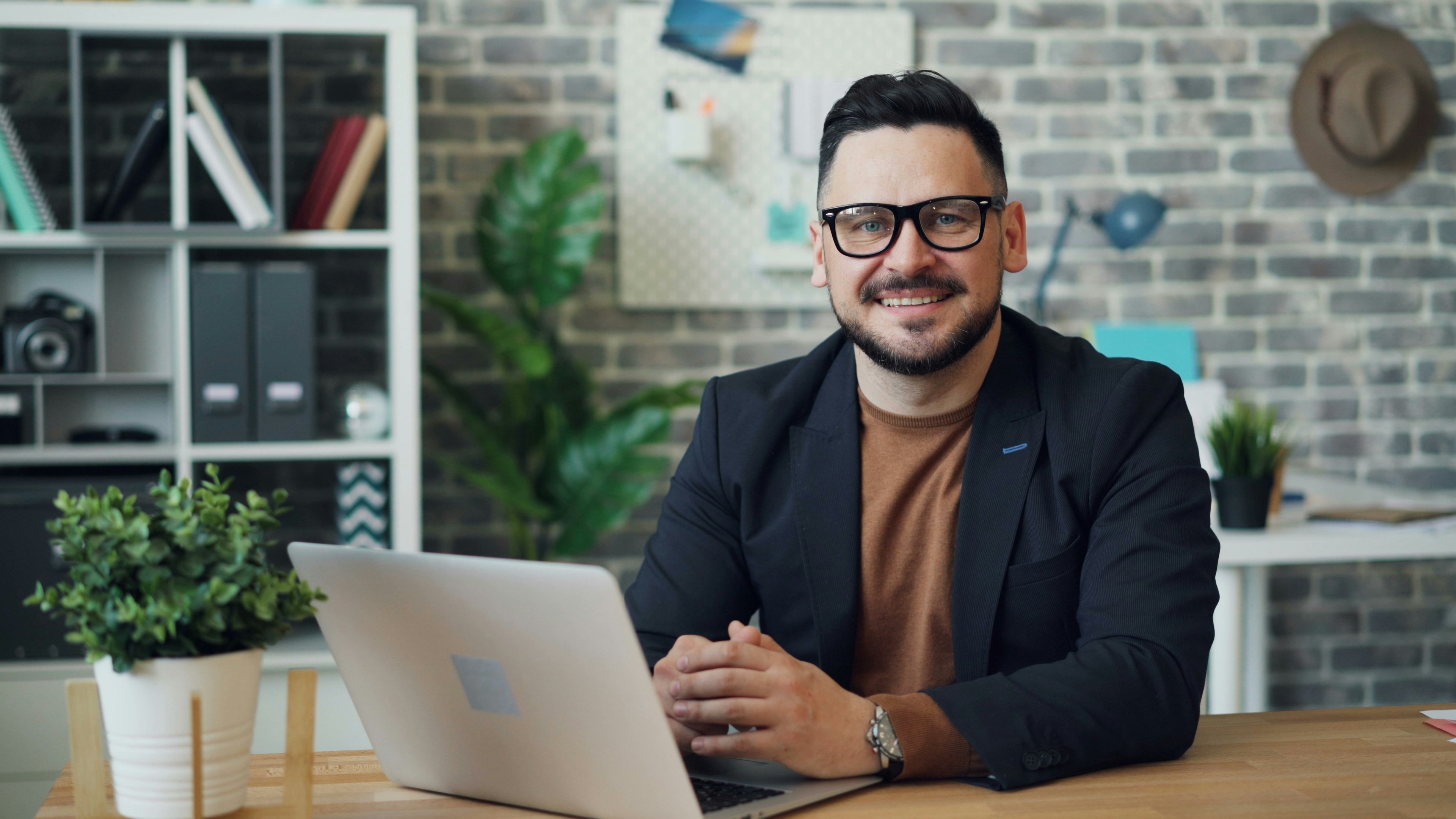 man with laptop in office - famous stock traders