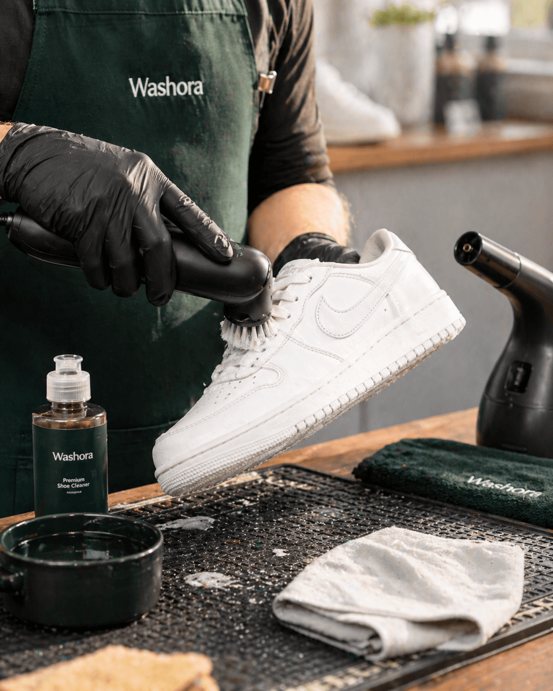 Washora shoe cleaning service with gloved cleaner detailing a white Nike sneaker