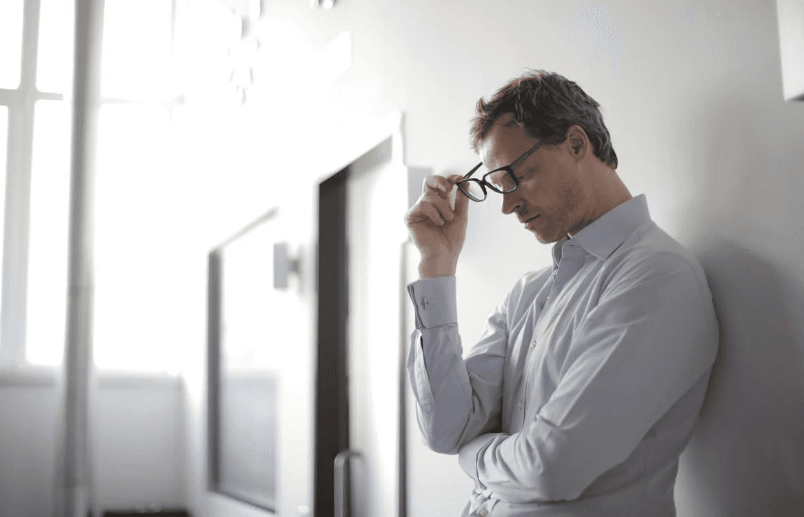 Photo Of Man Holding Black Eyeglasses, fustrated expression