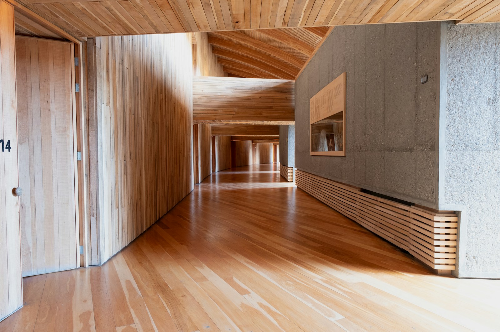 A wooden hallway with a modern minimalist design