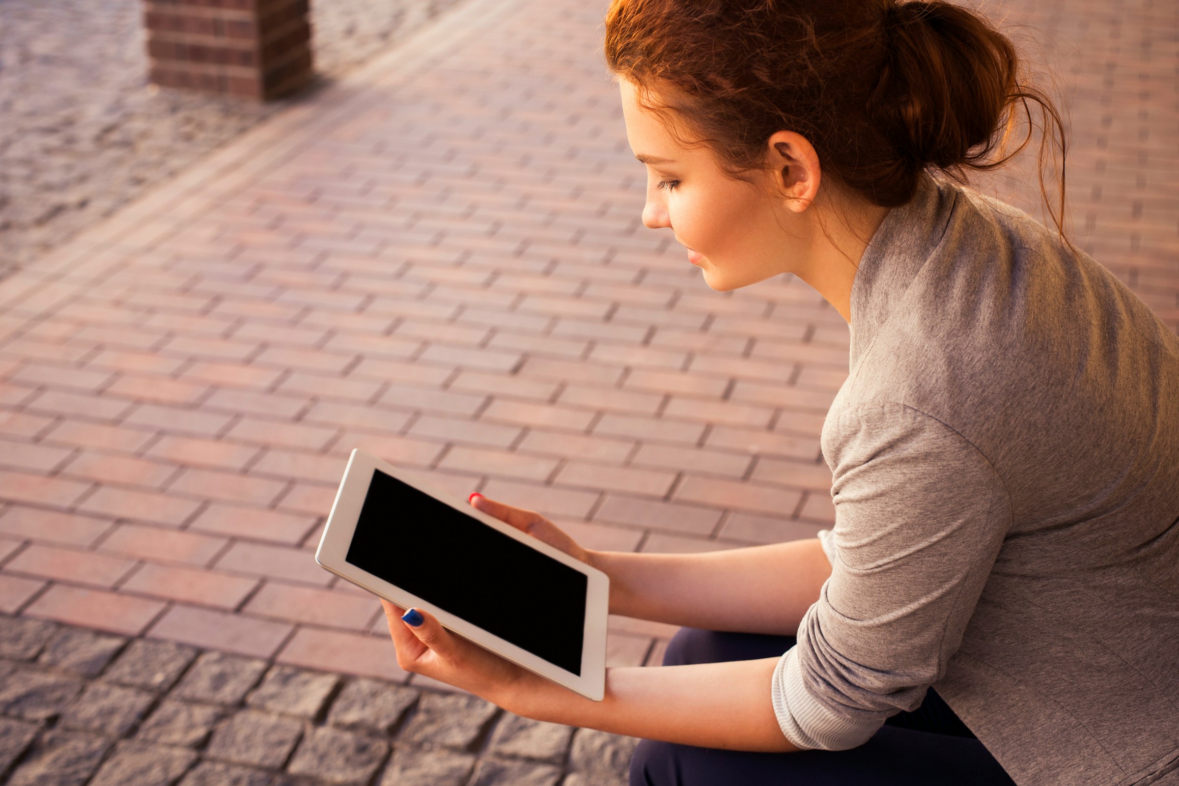 woman with tab in hand - Video Content Creation