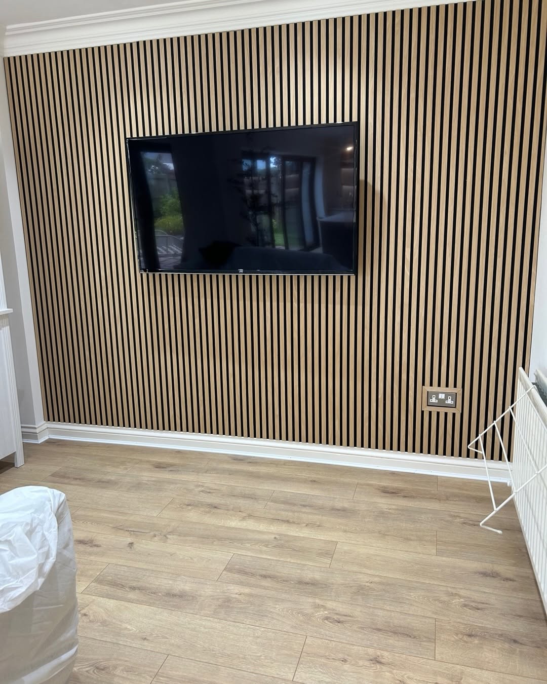 Oak slat media wall with concealed sockets