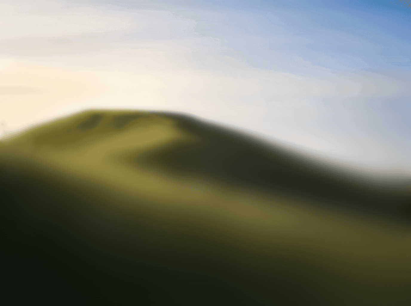Hill of grass on a sunny blue sky