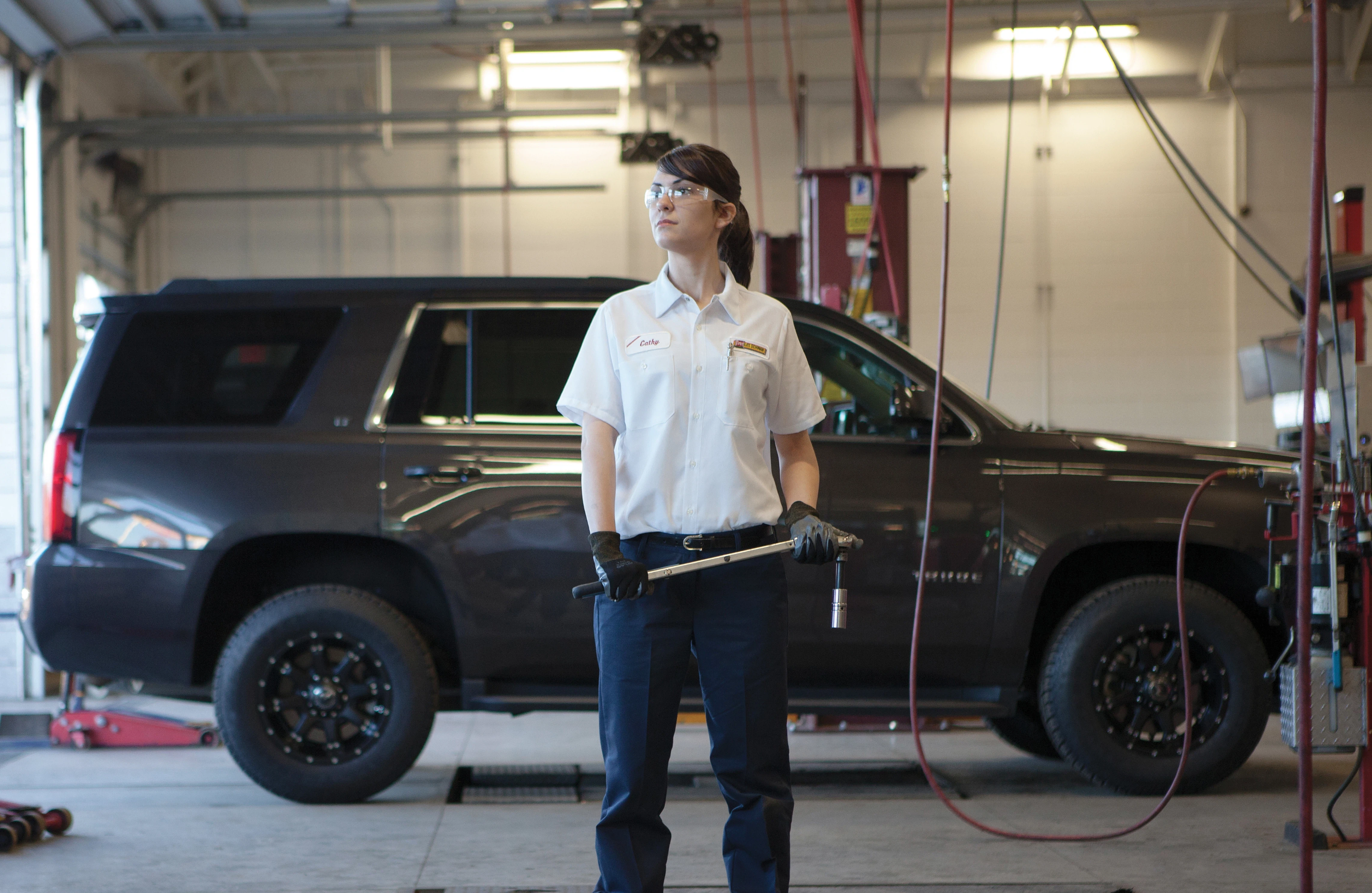 Employee in car mechanic bay