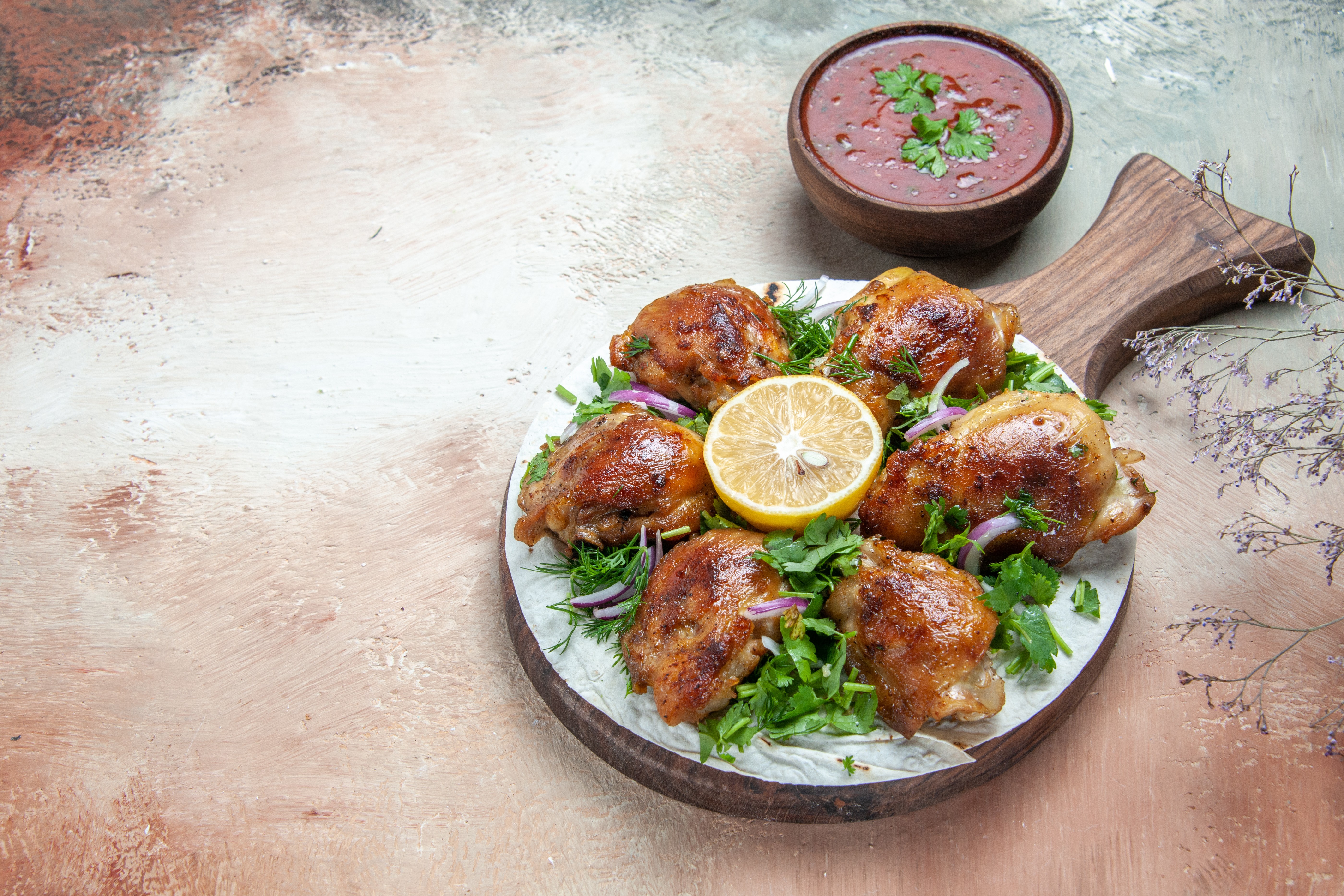 side vuew of chicken grilled with lemon in the center