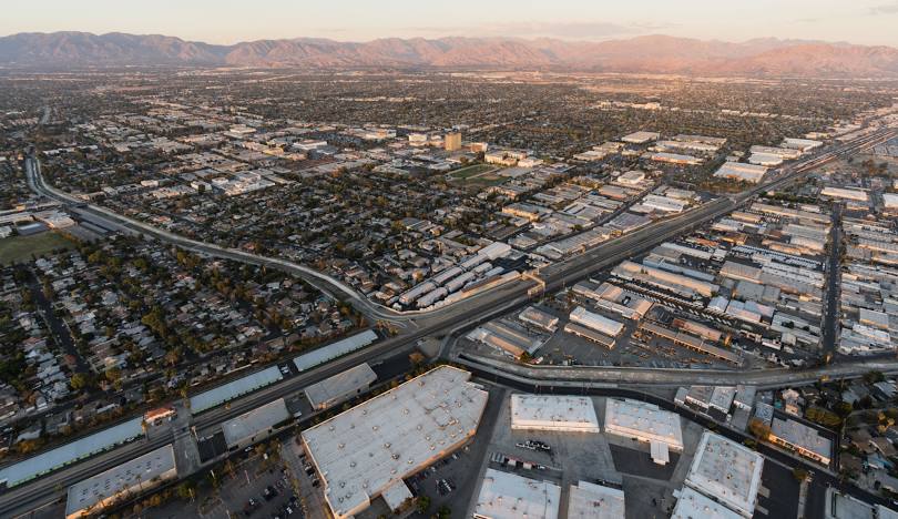 Aerial view of Van Nuys, California with mountains in the distance and Enterprise Self Storage facility.