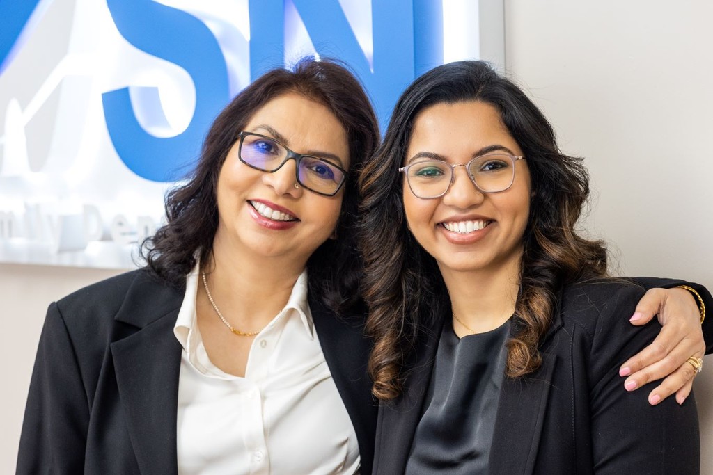 Dr. Navneet Rai and Dr. Simrann Rai Sethi smiling in the Milltown dental office