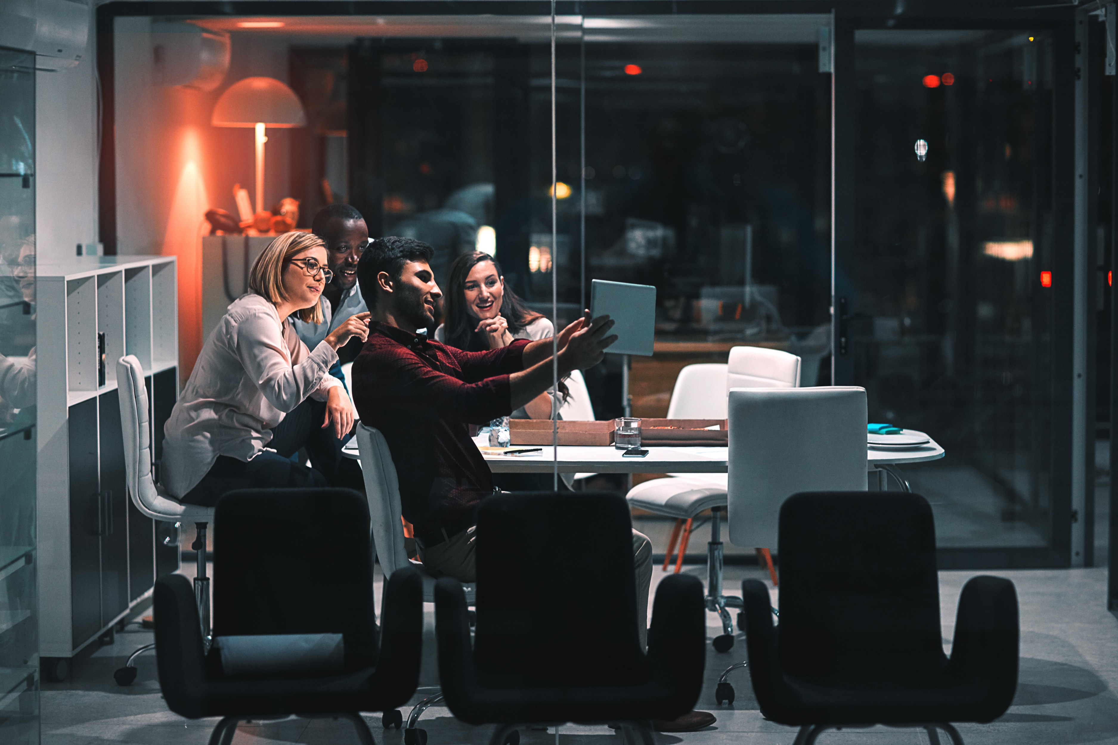 people sitting near table with laptop computer