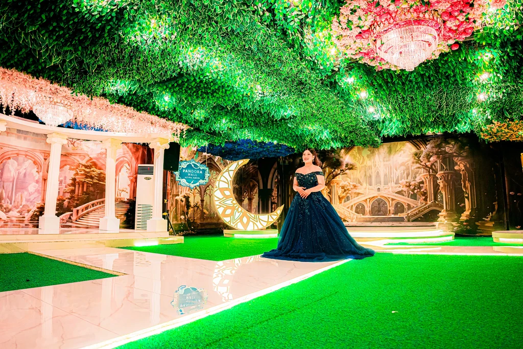 Debutante in navy walking the glowing green aisle of Pandora Hall