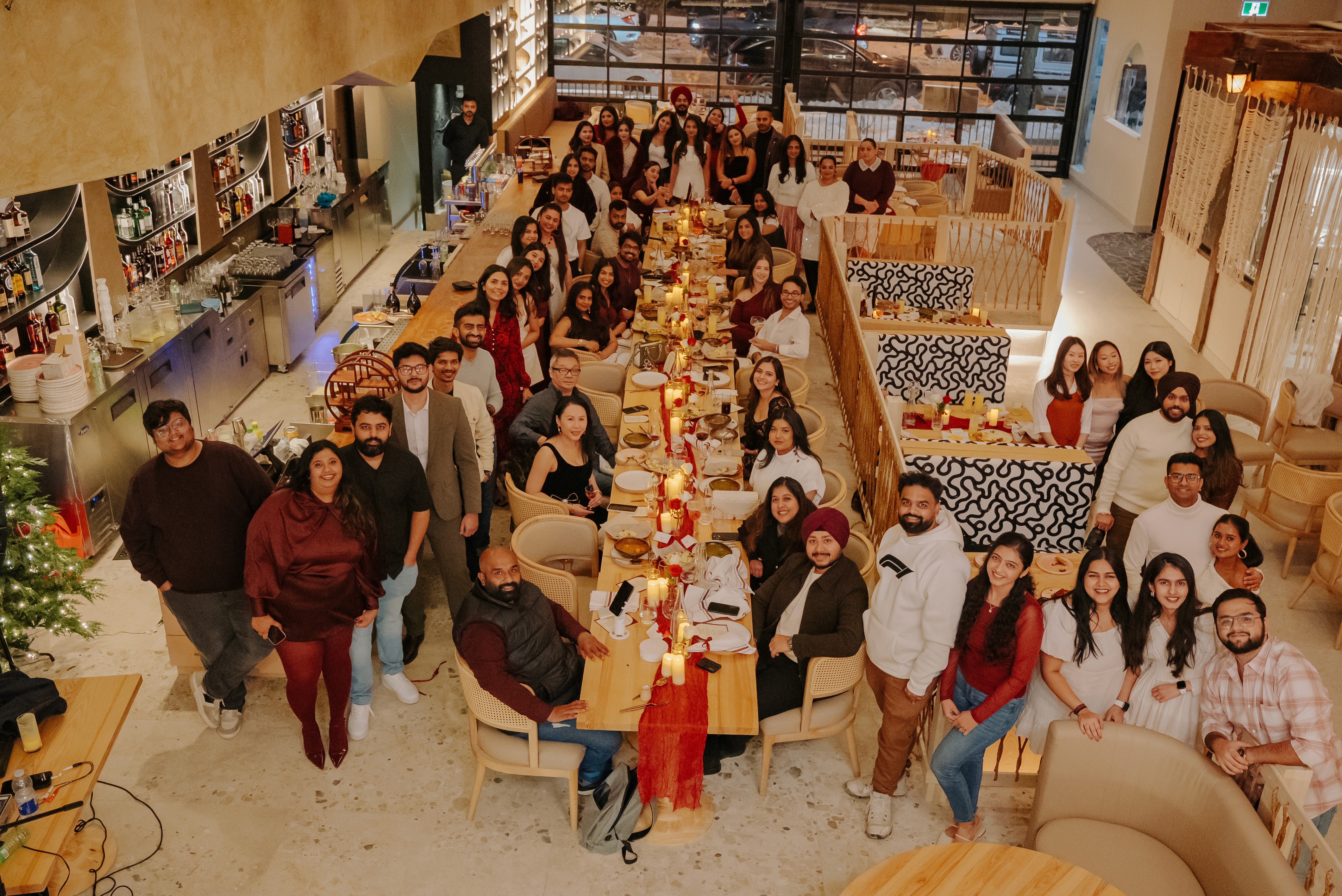 Guests gathered around a long communal table at Dhoom’s private tasting event, celebrating modern Indian dining and community before the official launch.