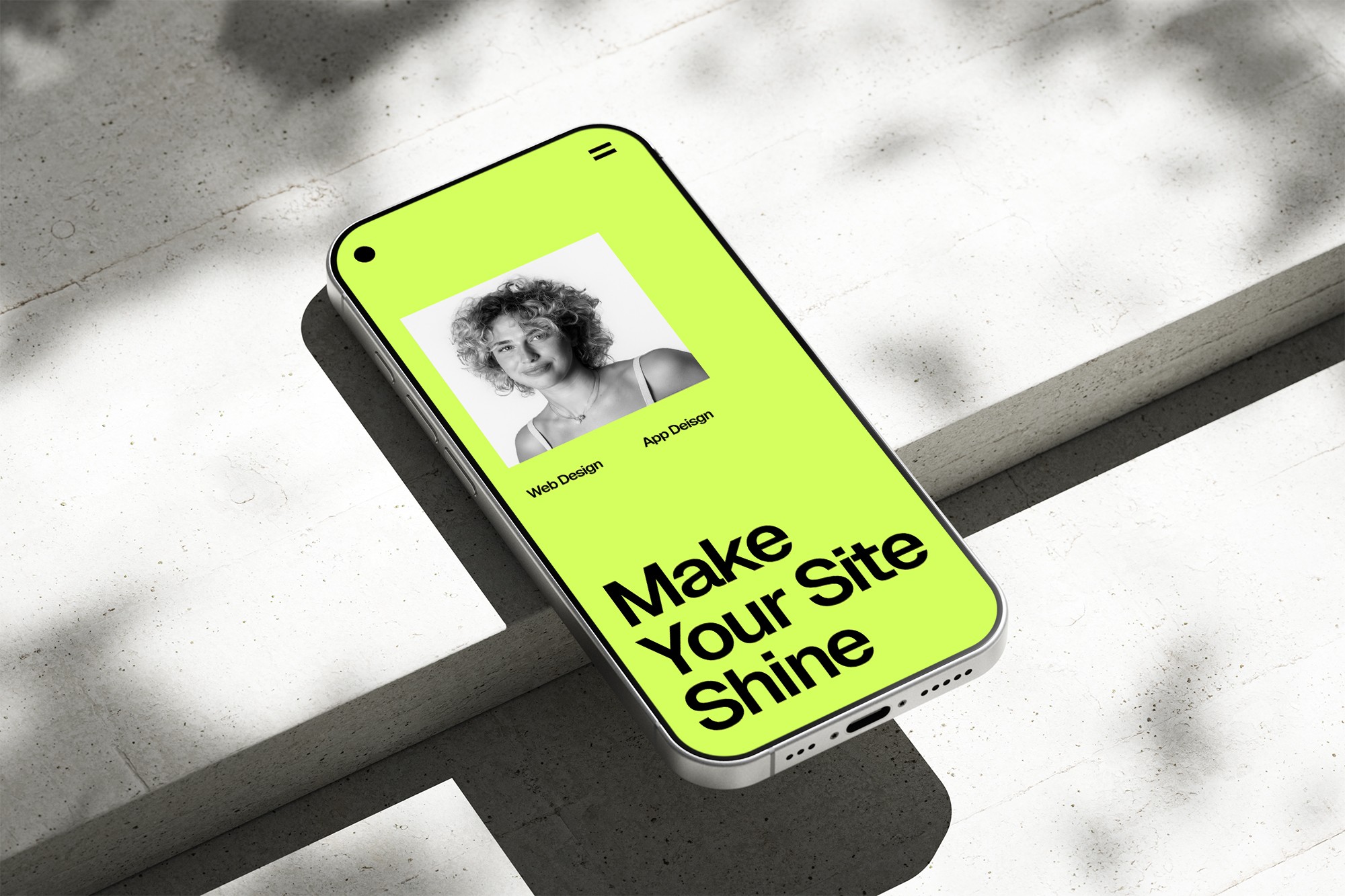 Phone on concrete, website on screen