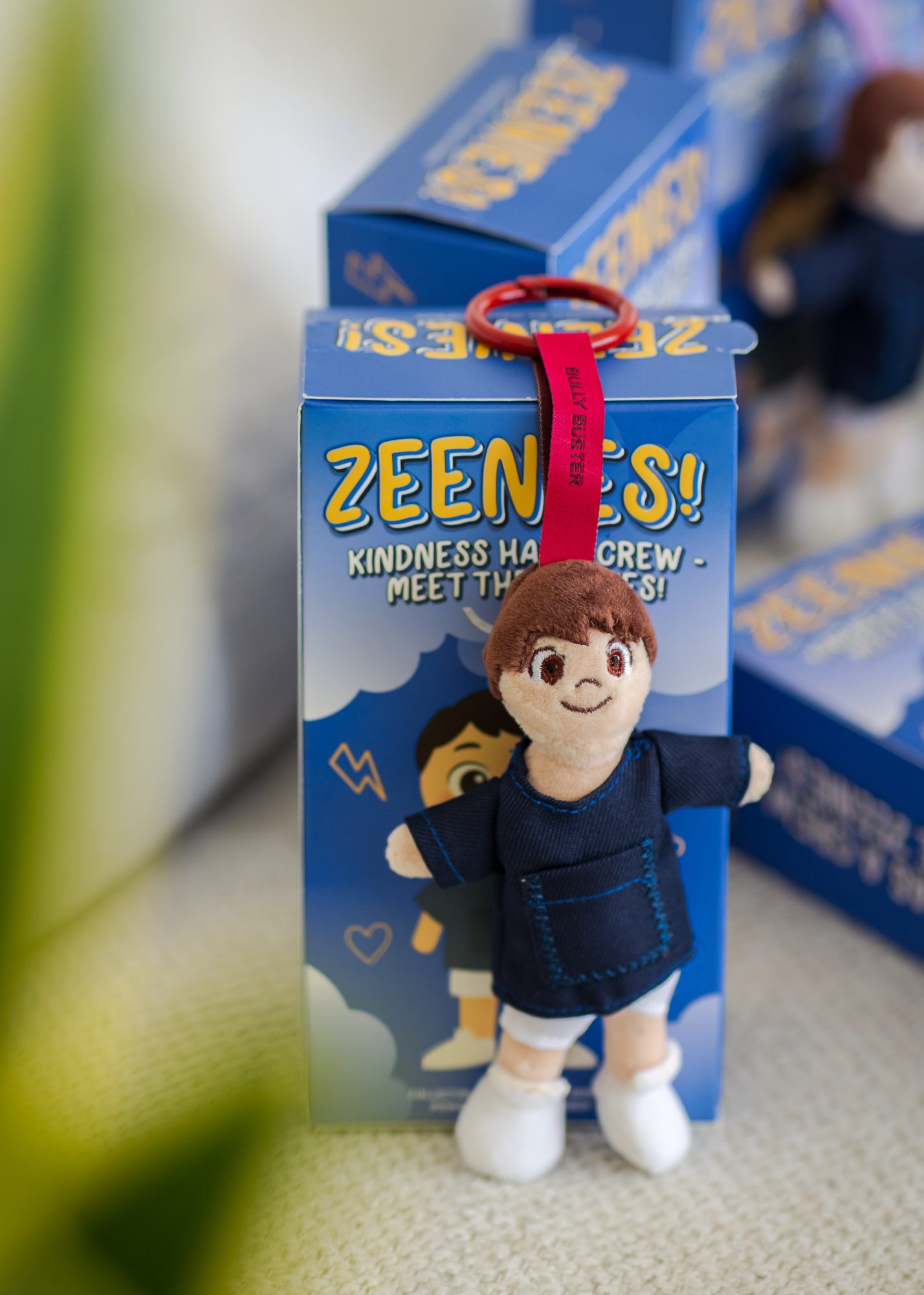 Small Zein The Boy plush doll in front of its blue Zeenies box.