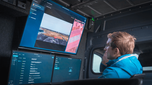Drone operator monitoring live video feed in mobile command unit using AirHub drone operations software