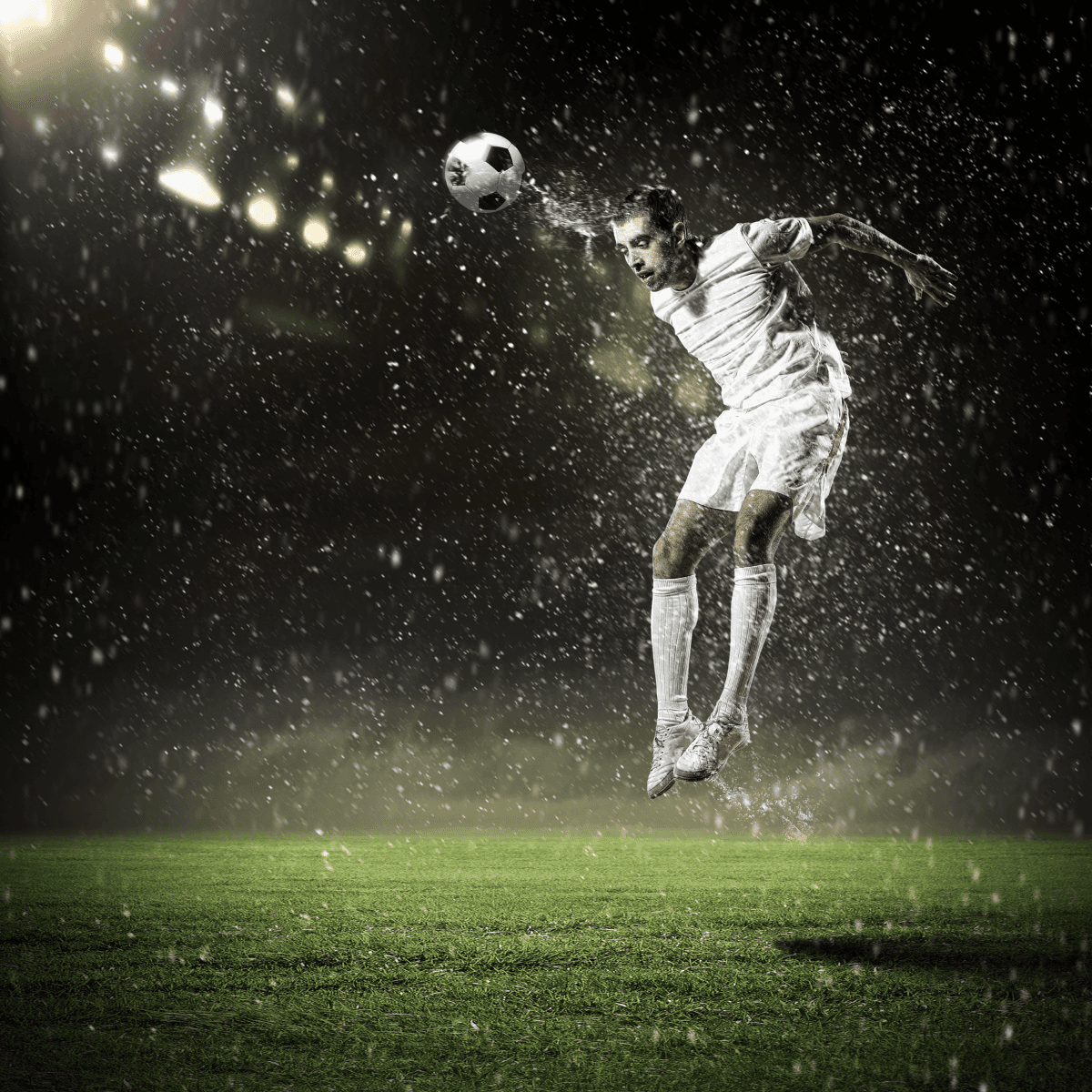 soccer player on the pitch surrounded by drops of water