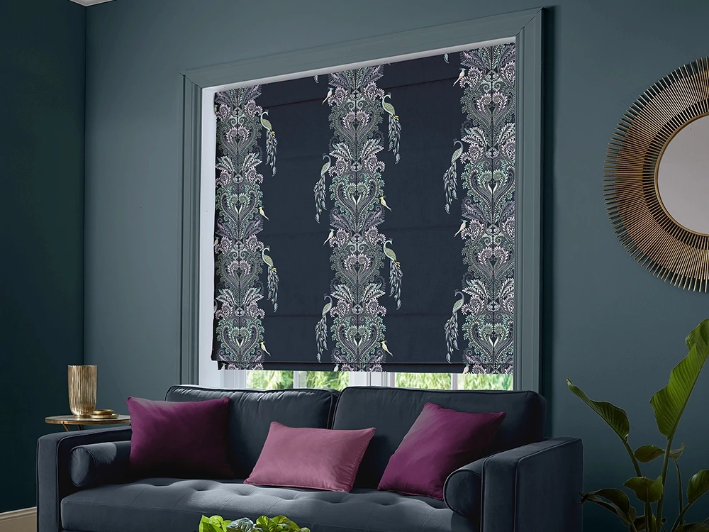 A dark living room with sofa and Sara Miller navy roman blind