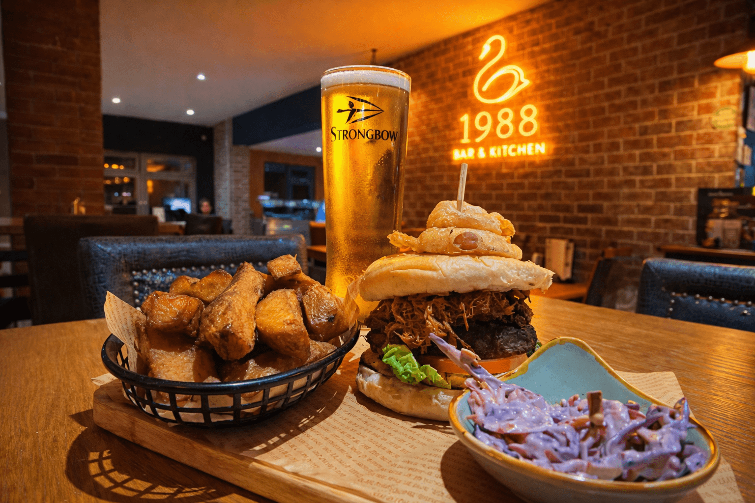 Close up of Burger and fries on a plate inside a bar