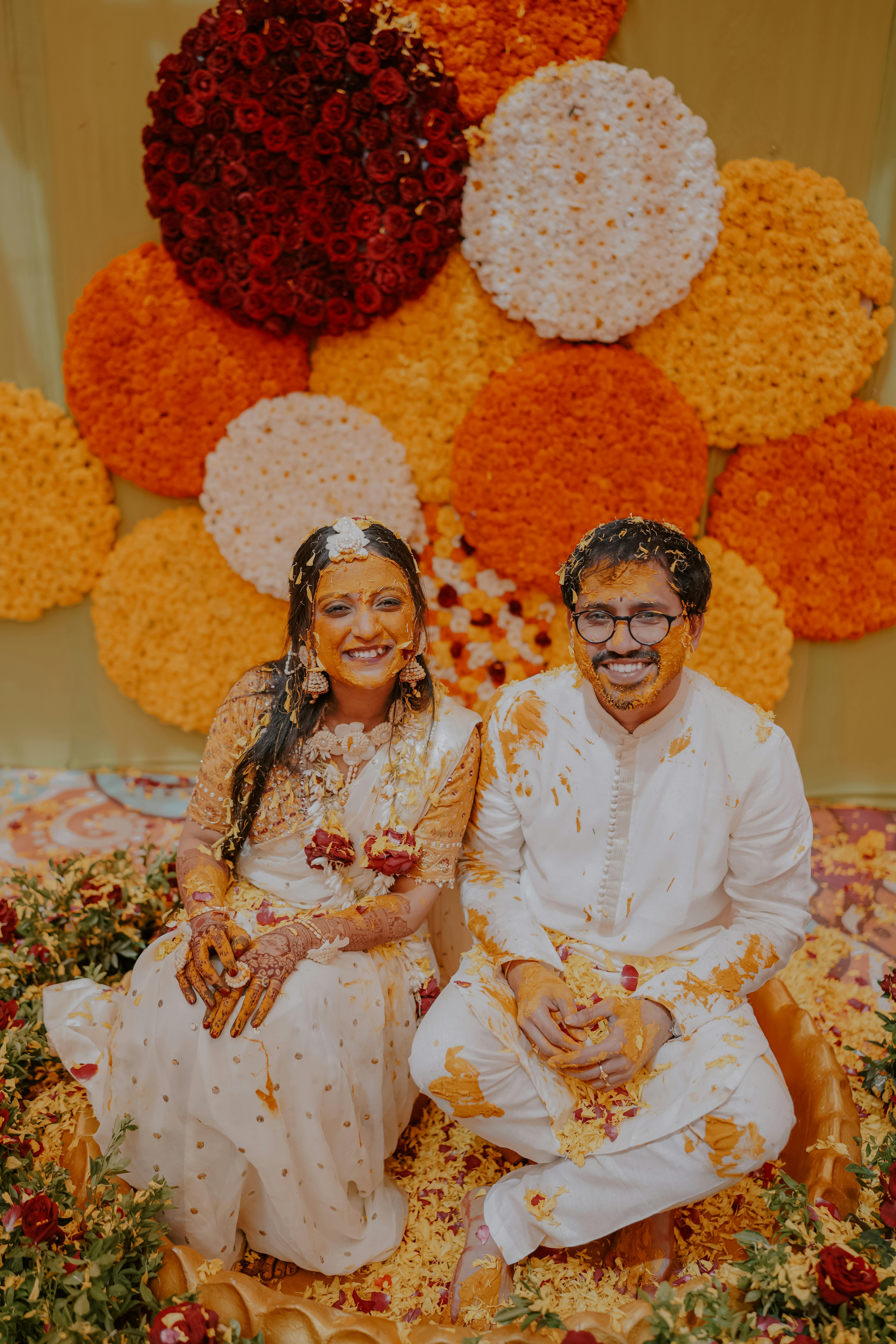 A serene outdoor lounge area with two chairs surrounded by lush greenery and natural light streaming in.