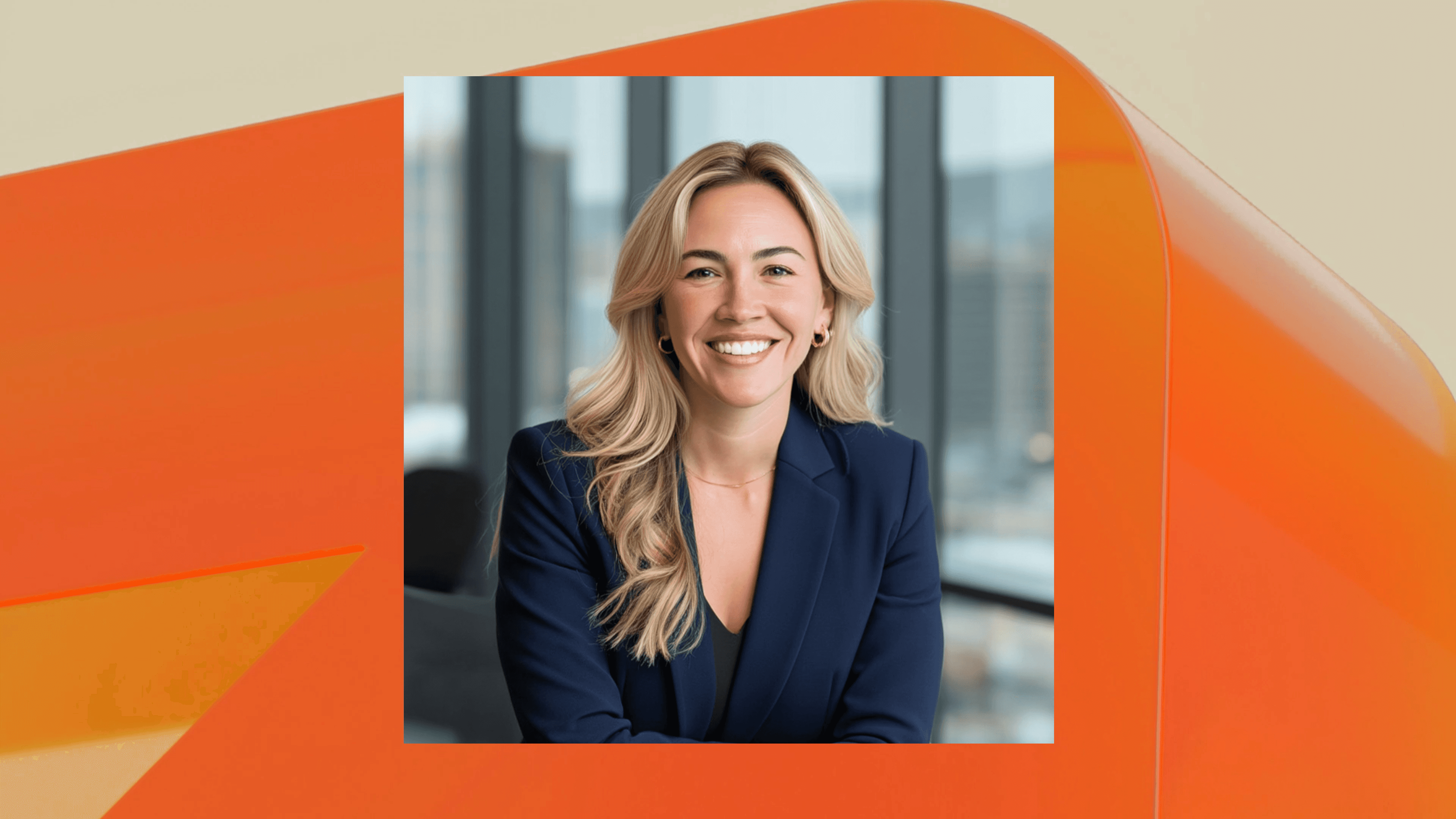 Professional portrait of a smiling woman in a business setting with a blurred office background