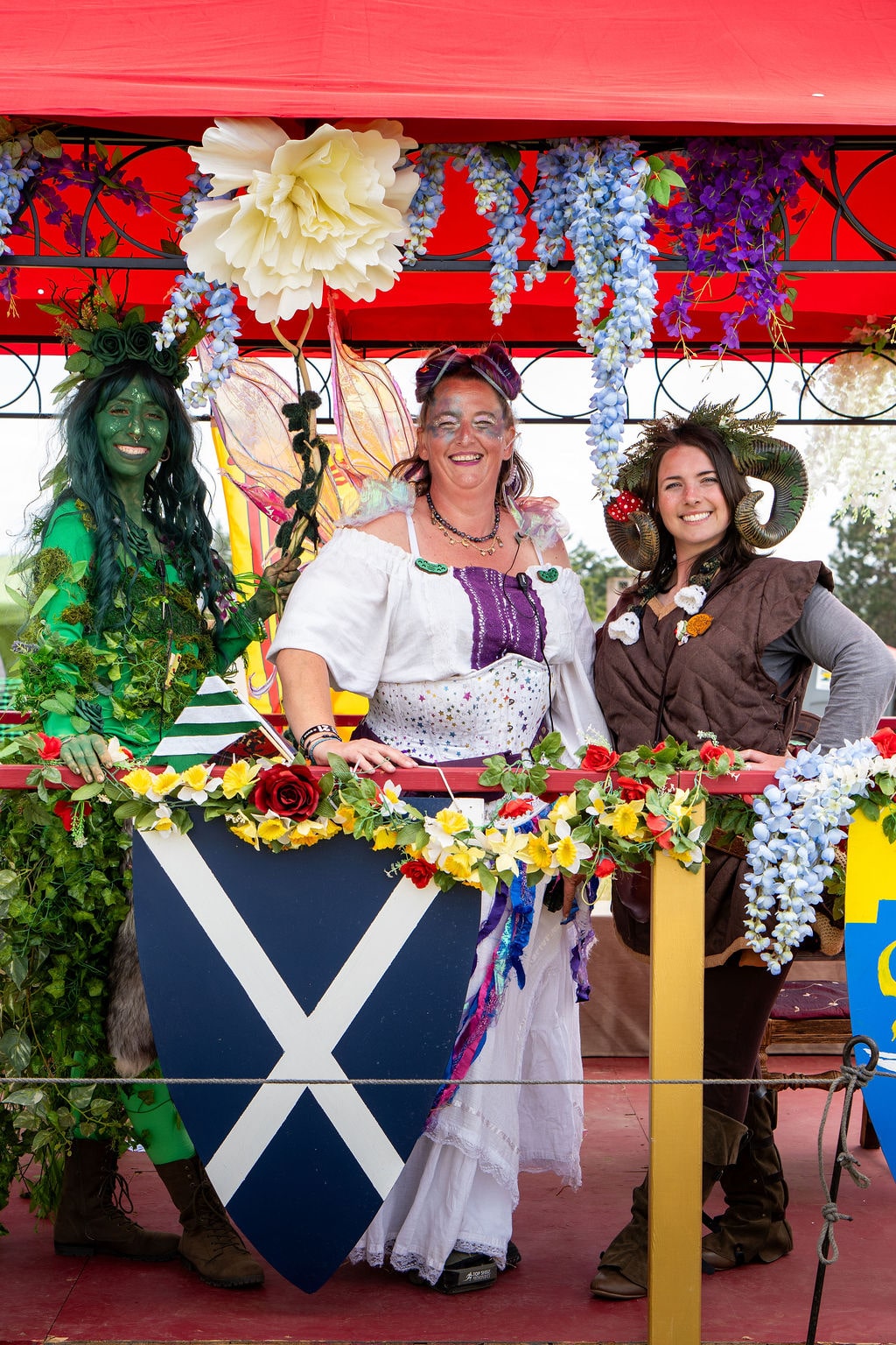 Three volunteers, one fairy, one with horns, one as green goddest