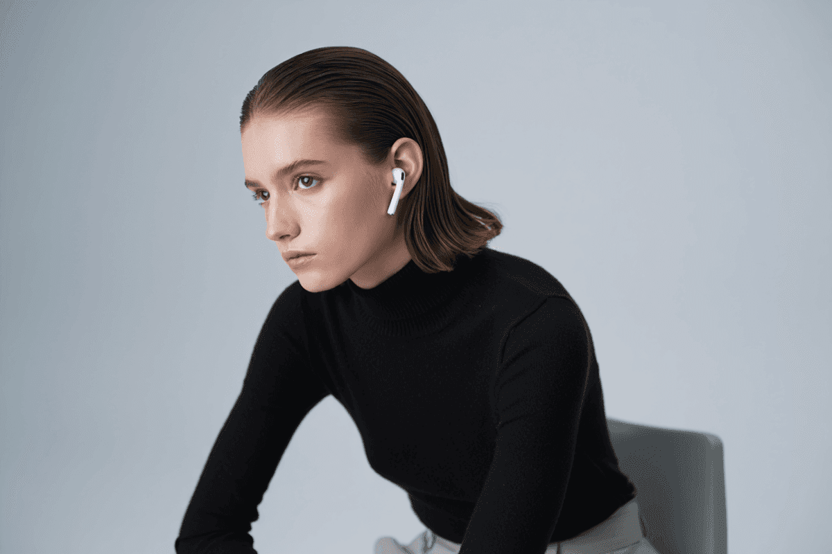 woman sitting with airpods on
