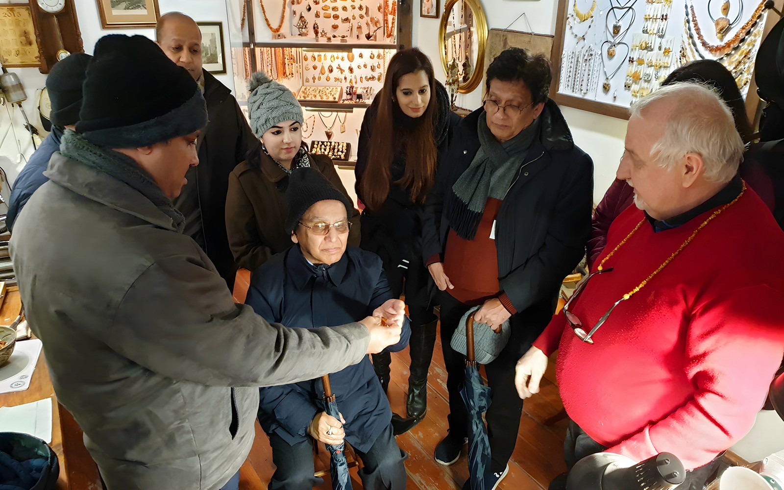 Group observing amber crafting demonstration at Gdańsk workshop.