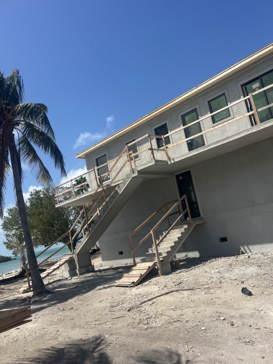 Modern bathroom featuring wooden cabinetry, a bathtub, a sleek sink, and natural light from a window.
