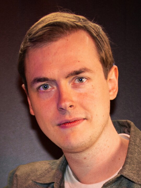 A person with glasses and a beard looking at the camera.