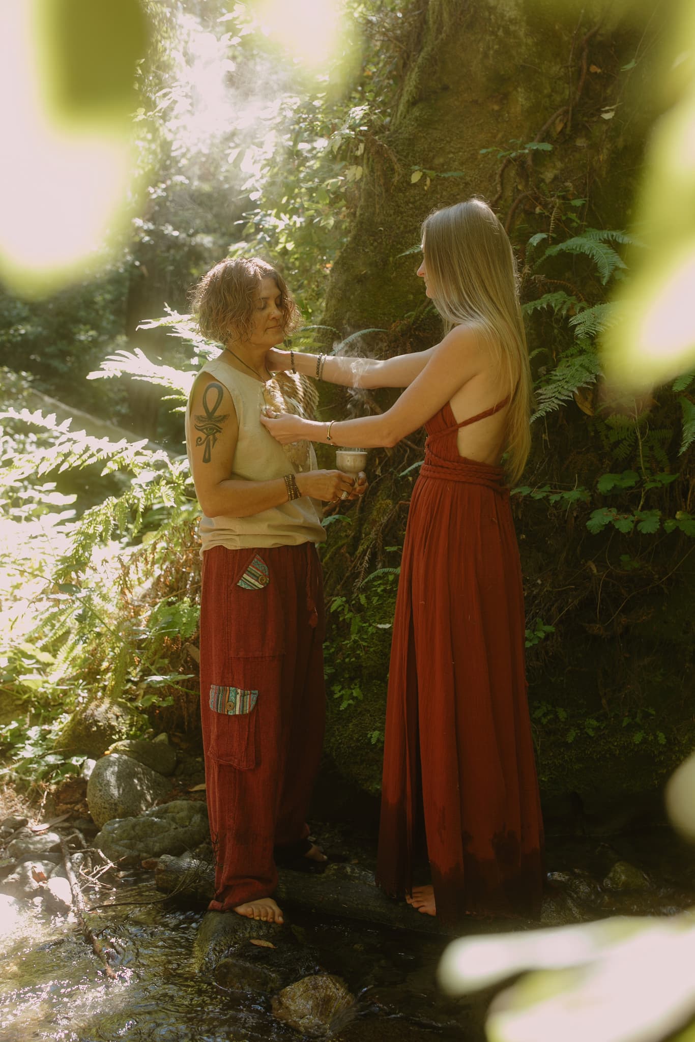 Hands passing ceremonial cup during psilocybin mushroom ceremony at Tree of Life Temple