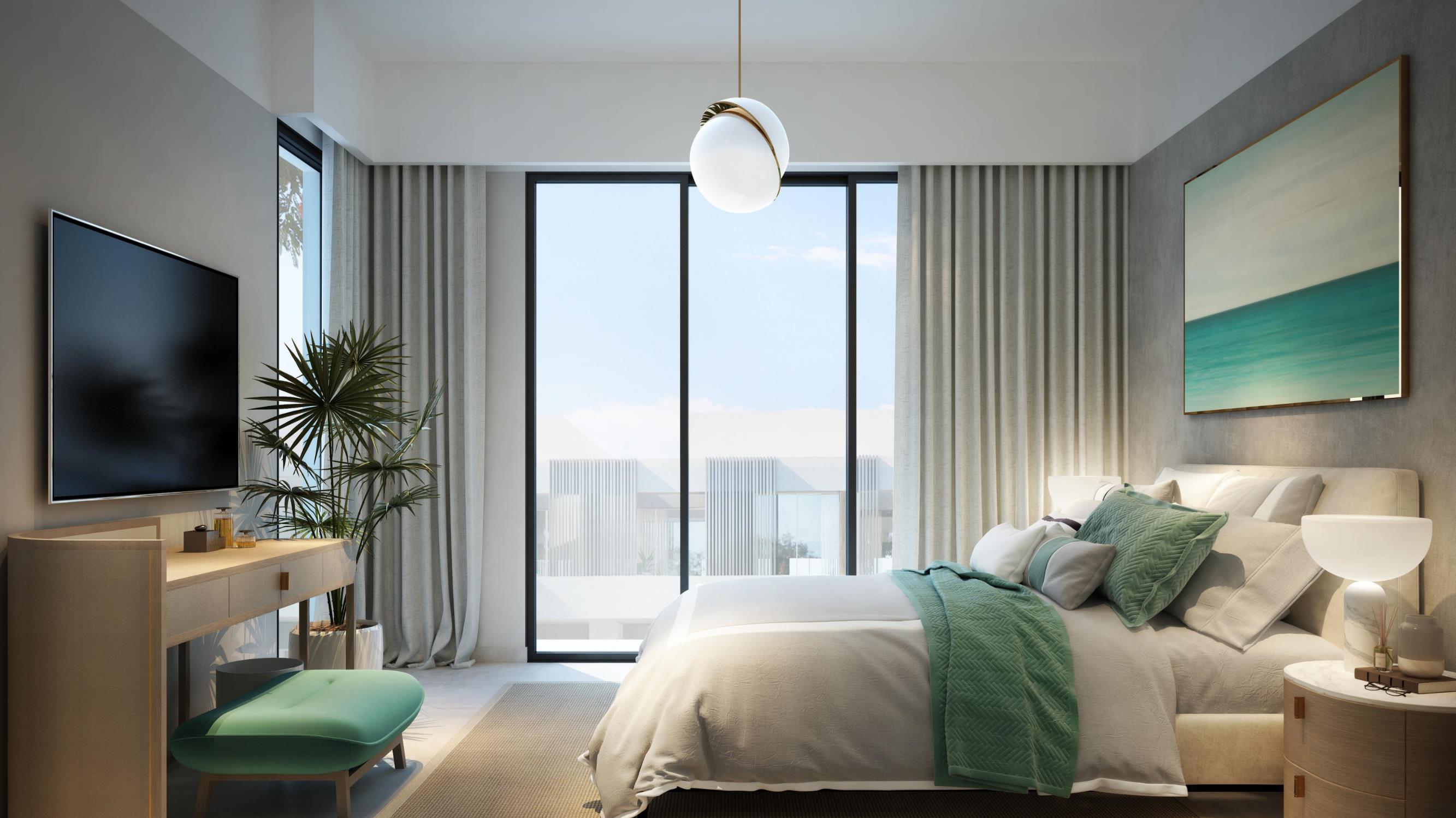 A modern bedroom featuring a large window with a view of the ocean, located at Talia at the Valley.
