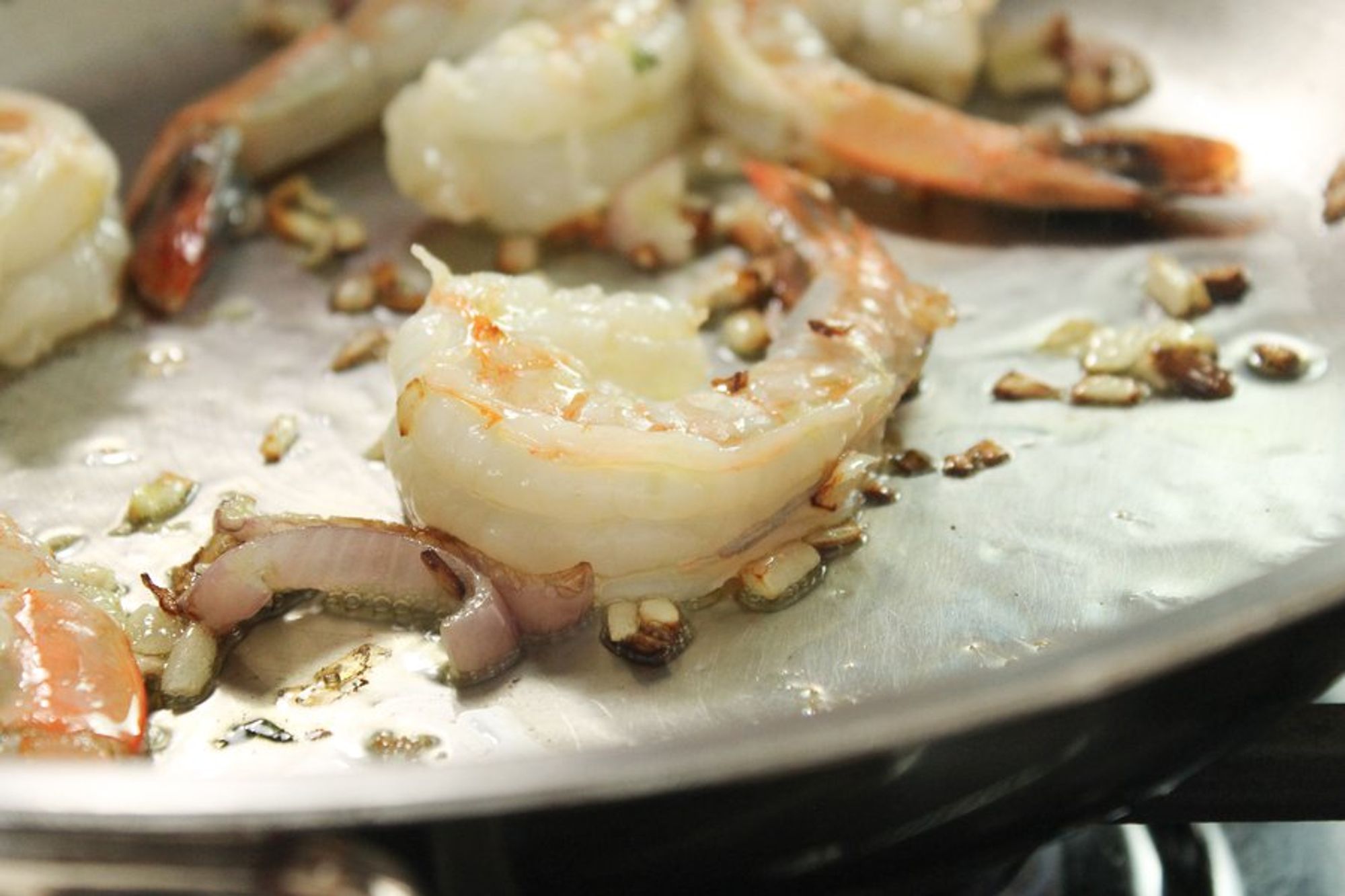 shrimps being cooked in a pan